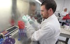 Josh Owens, a bio-repository technician, processes a blood sample, post transplant, at the Be the Match repository in New Brighton. Tuesday, July 21, 