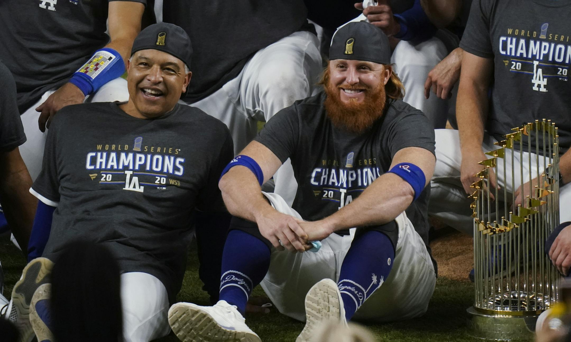 Los Angeles Dodgers manager Dave Roberts and third baseman Justin Turner pose for a group picture after the Dodgers defeated the Tampa Bay Rays 3-1 in Game 6 to win the baseball World Series, Tuesday, Oct. 27, 2020, in Arlington, Texas. (AP Photo/Eric Gay)