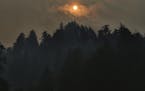 Smoke clouds from the Eagle Creek Fire obscure the sun above Multnomah Falls, Wednesday, Sept 6, 2017, near Troutdale, Ore (Genna Martin/seattlepi.com