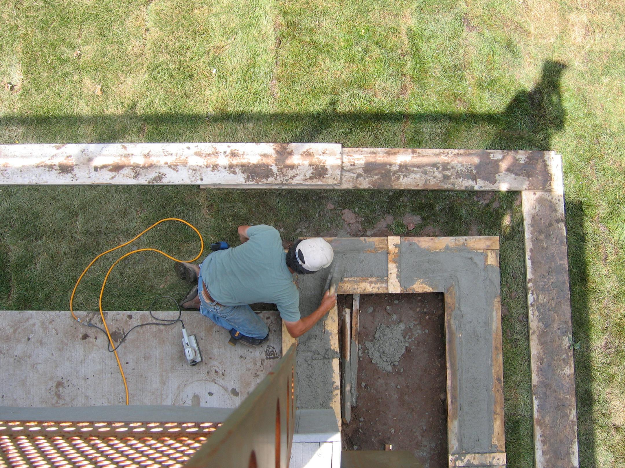 Fred puts the finishing touch on the second of two rain gardens, off the back of the house.