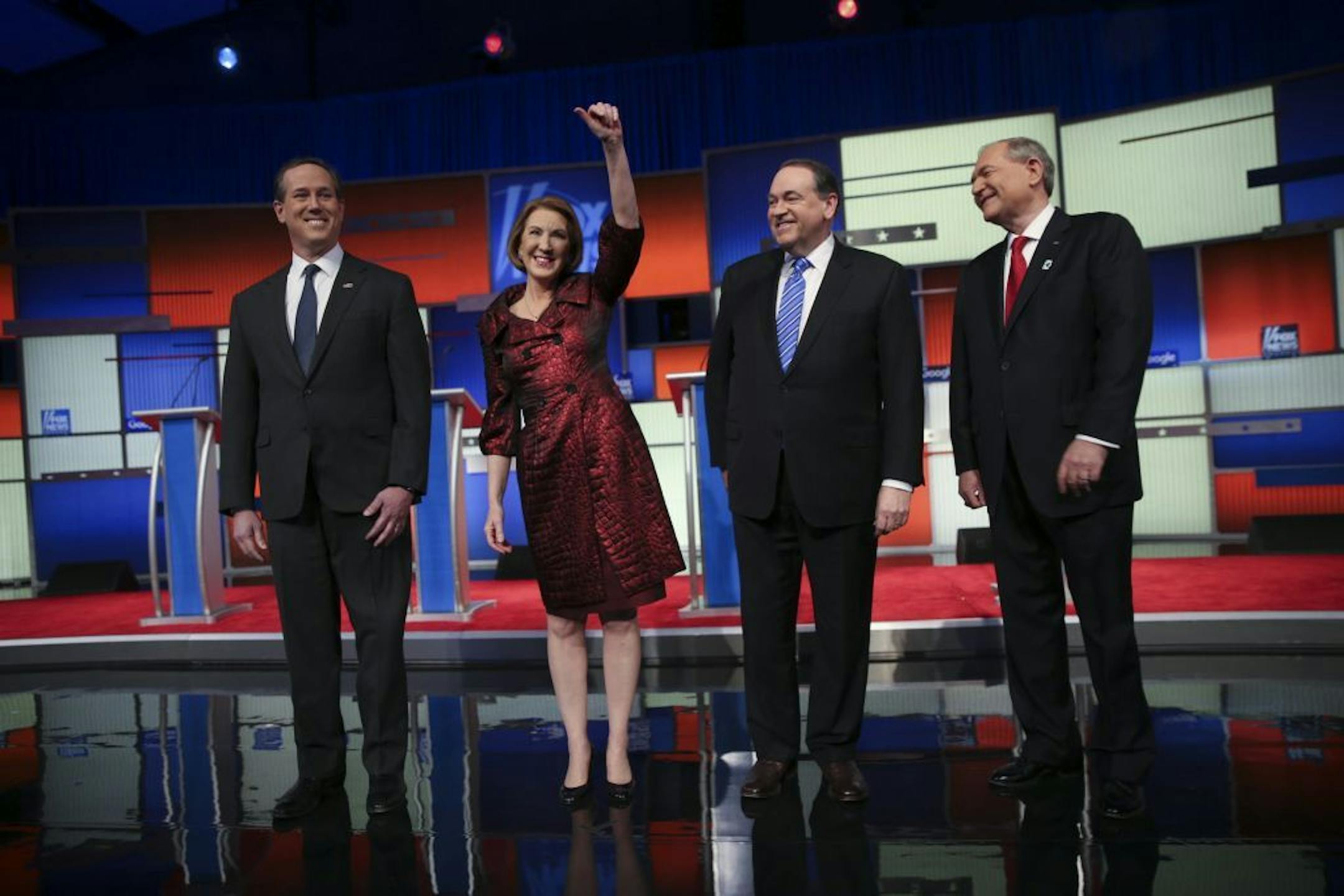 From left: Rick Santorum, Carly Fiorina, Mike Huckabee and Jim Gilmore take the stage for the first of two Republican presidential primary debates at the Iowa Events Center in Des Moines, Jan. 28, 2016. Santorum and Huckabee have said they will attend Donald Trump�s event for veterans running concurrent to the main debate later Thursday.