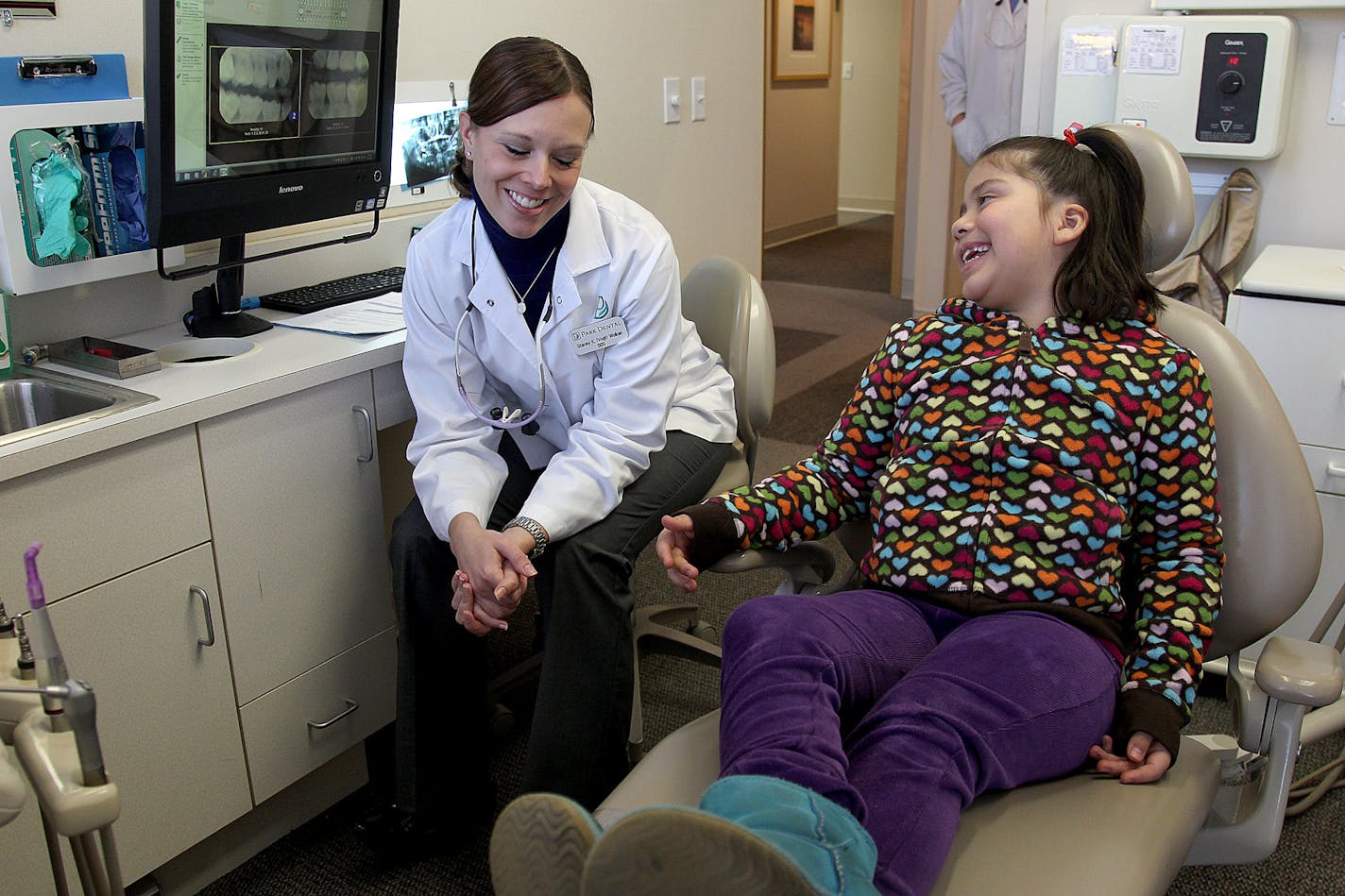 Park Dental dentist Stacey K. (Vogt) Wolken, DDS, gave an assessment to patient Zoe Medina, 7, at the Eden Prairie Park Dental office, Friday, February 1, 2013. Medina was one of 32 patients signed up to get free dental care. The entire Park Dental staff came in on a voluntary basis to work for Give Kids a Smile. The organization is a charitable program coordinated by the Minnesota Dental Association to provide free care to low-income children in need. The two-day, statewide event is Friday, Feb