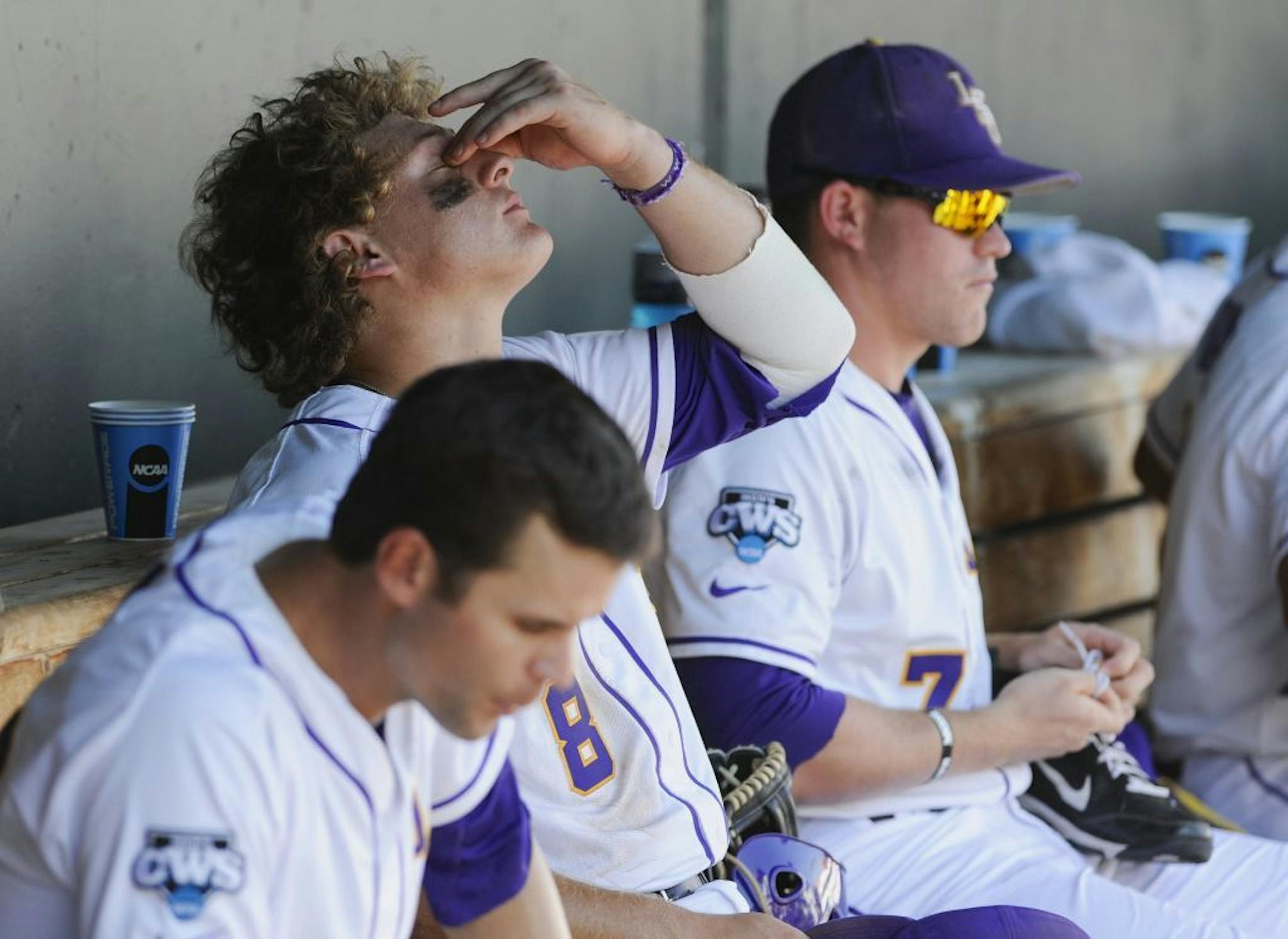LSU players, including Mason Katz (8) and Sean McMullen (7) react in the dugout after losing 4-2 to North Carolina in an NCAA College World Series elimination game in Omaha, Neb., Tuesday, June 18, 2013.