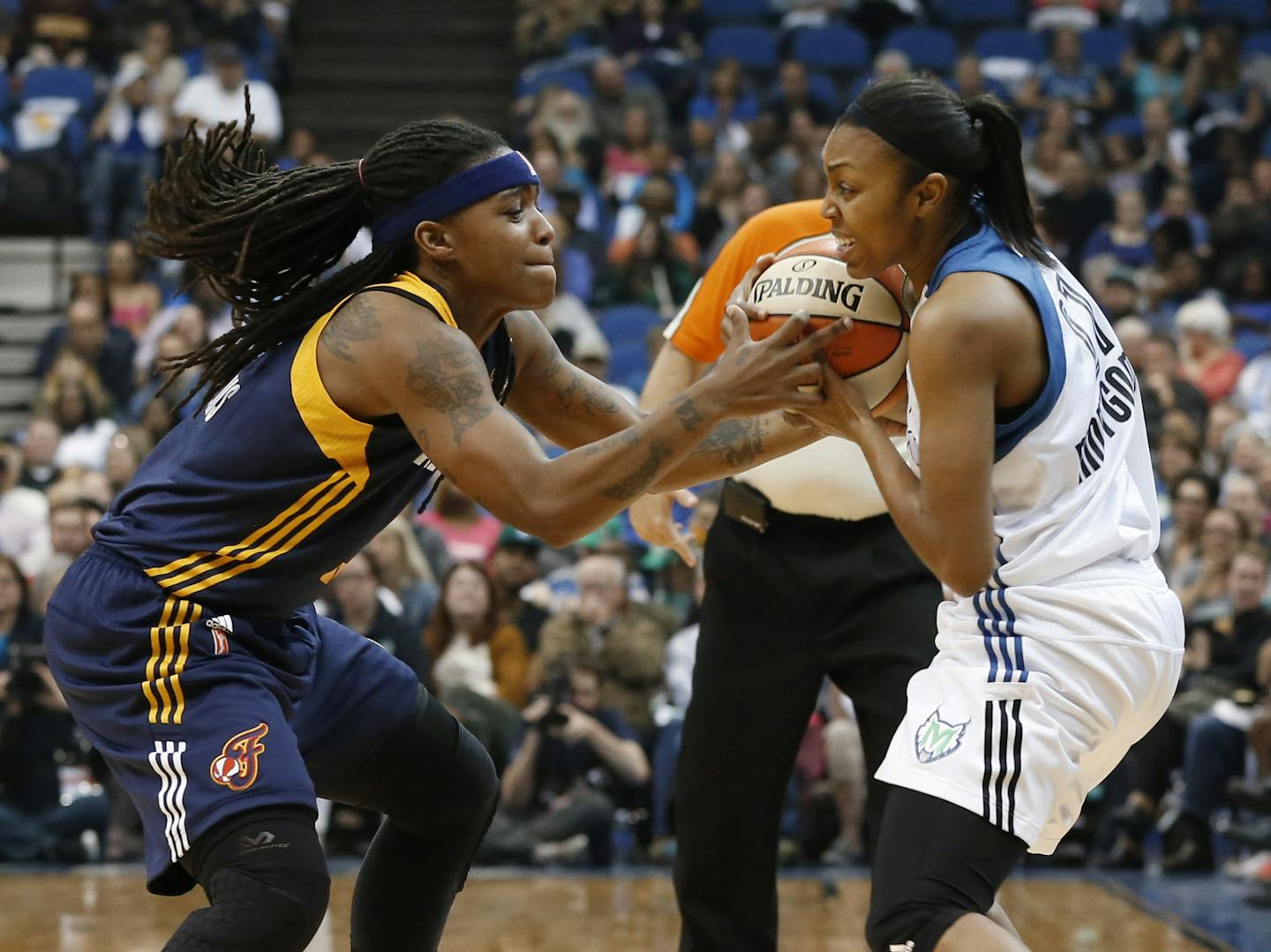 Indiana Fever guard Shavonte Zellous, left, and Minnesota Lynx guard Renee Montgomery battle fort the ball in the second half of Game 2 of the WNBA basketball finals Tuesday, Oct. 6, 2015, in Minneapolis. (AP Photo/Jim Mone)