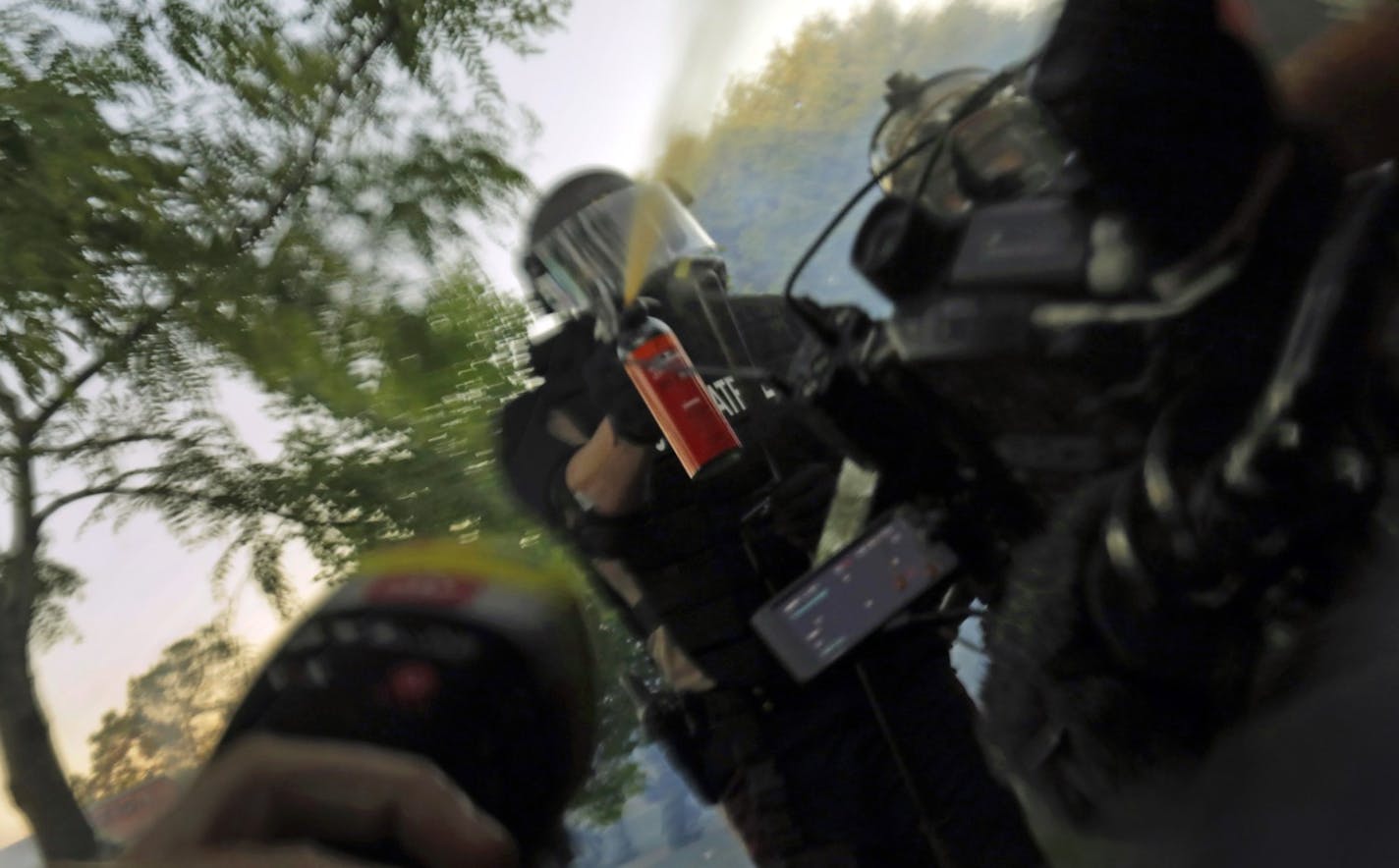 Minnesota State Patrol officers spray journalists with pepper spray and fire rubber bullets while they are working, despite their exemption from the curfew on Saturday. (Carolyn Cole/Los Angeles Times/TNS) ORG XMIT: 1679537