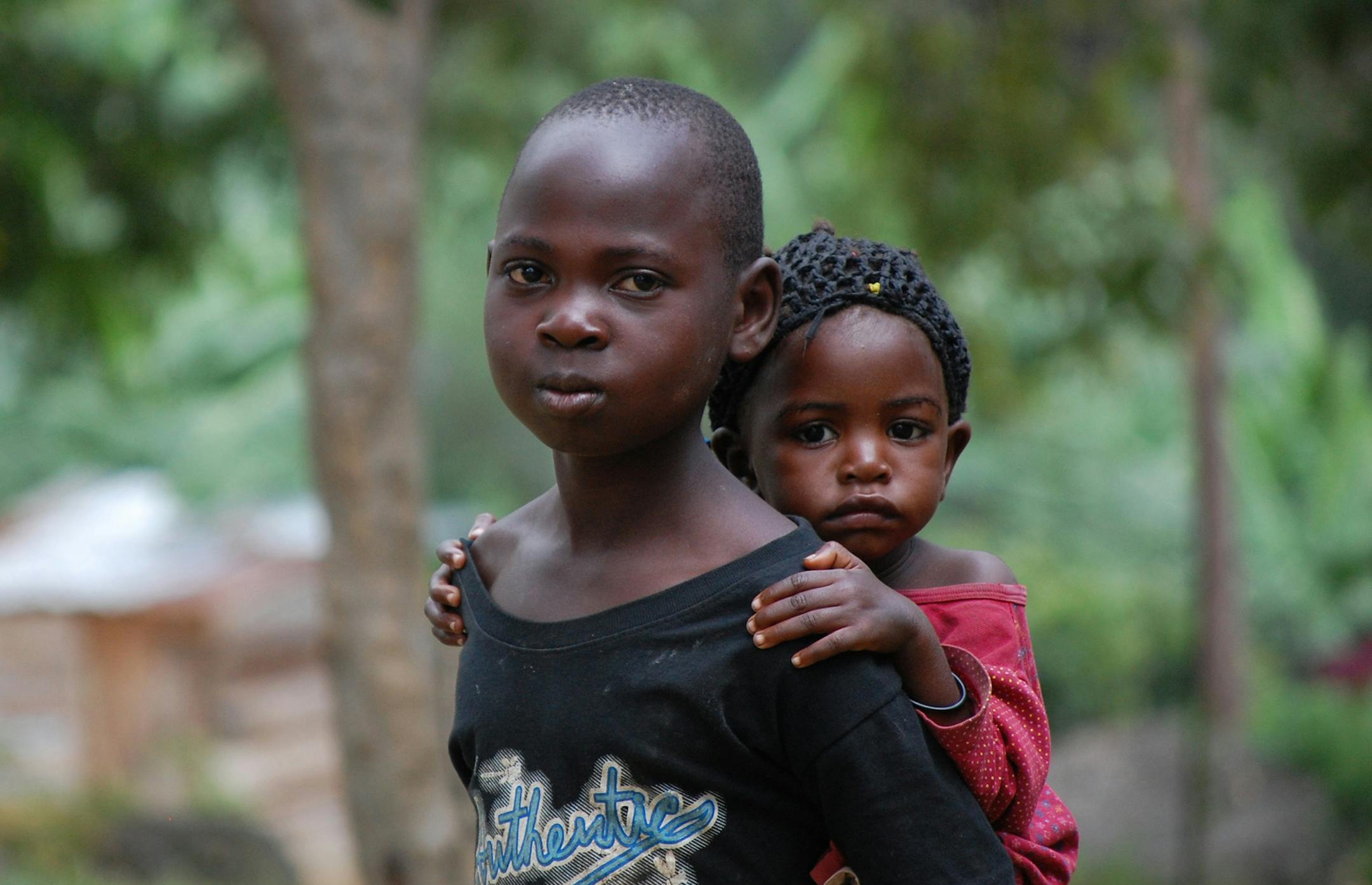 2. A brother gives his sister a lift in Nabugoye, a Jewish village in Uganda (photo by Curt Brown) ugandaTR032413