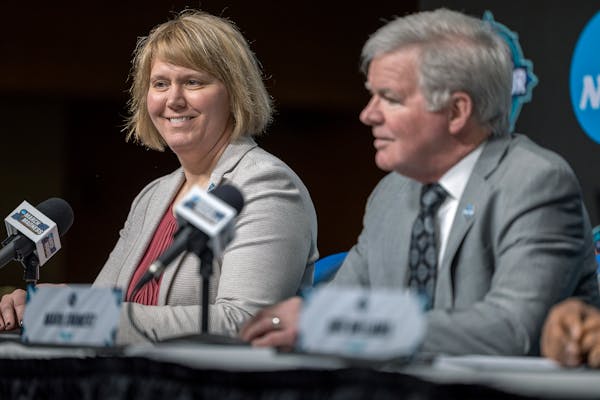 Lynn Holzman, left, NCAA vice president for women's basketball, and Mark Emmert, NCAA president, attend a a news conference Wednesday, March 30, 2022,
