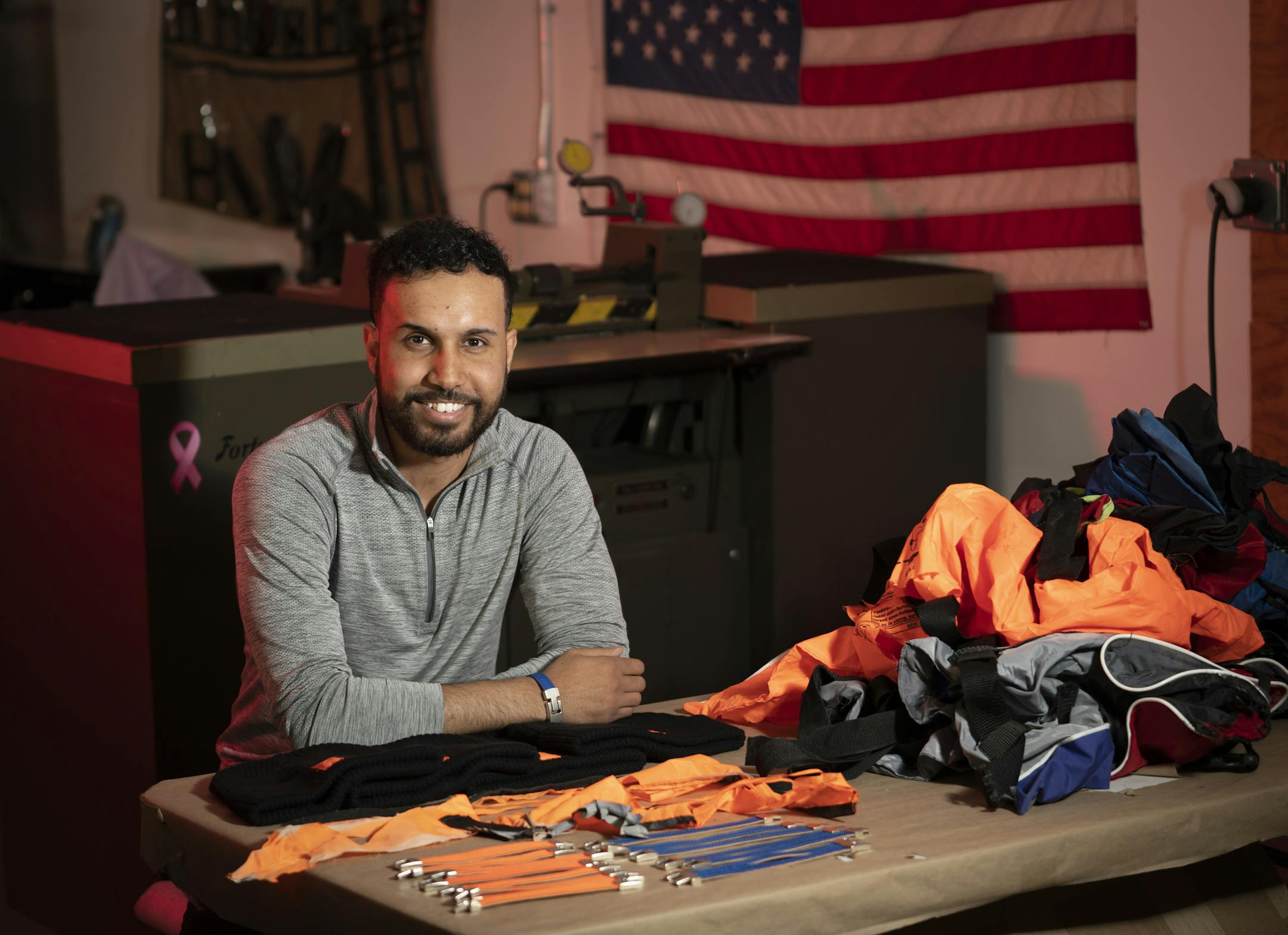 Mohamed Malim, 23, founded a company called Epimonia that makes bracelets and hats out of repurposed life jackets the refugees have likely used during boat trips to Greece. He posed for a photo in the production facility where the product is made in Maplewood, Minn., on Tuesday, November 26, 2019. ] RENEE JONES SCHNEIDER • renee.jones@startribune.com