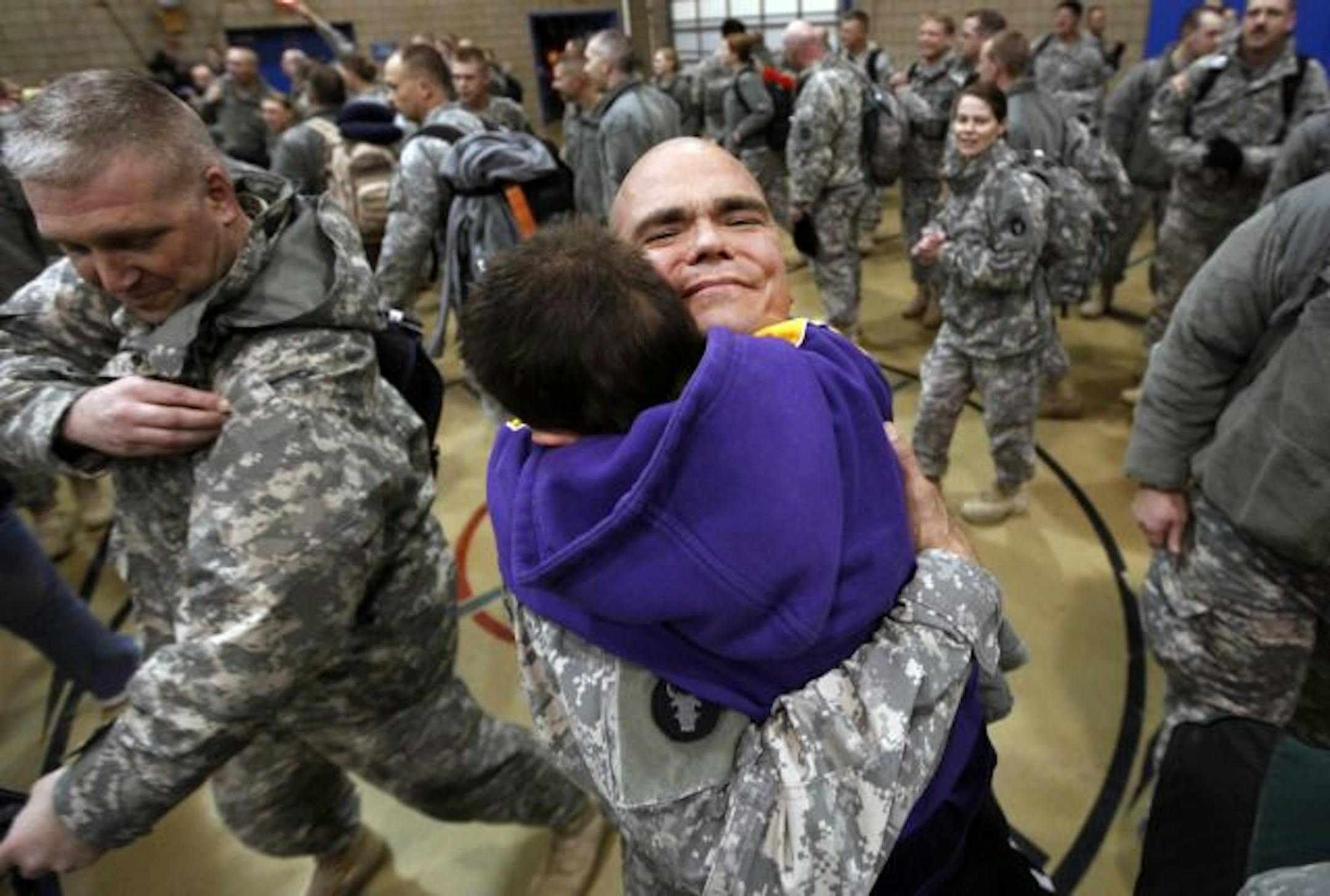 Sgt. Shawn Lidberg of Andover hugged his son, Tony, 8, at a "Welcome Home" ceremony at the Rosemount Armory Jan. 24. Lidberg served 11 months in Iraq with the 34th Infantry Division.