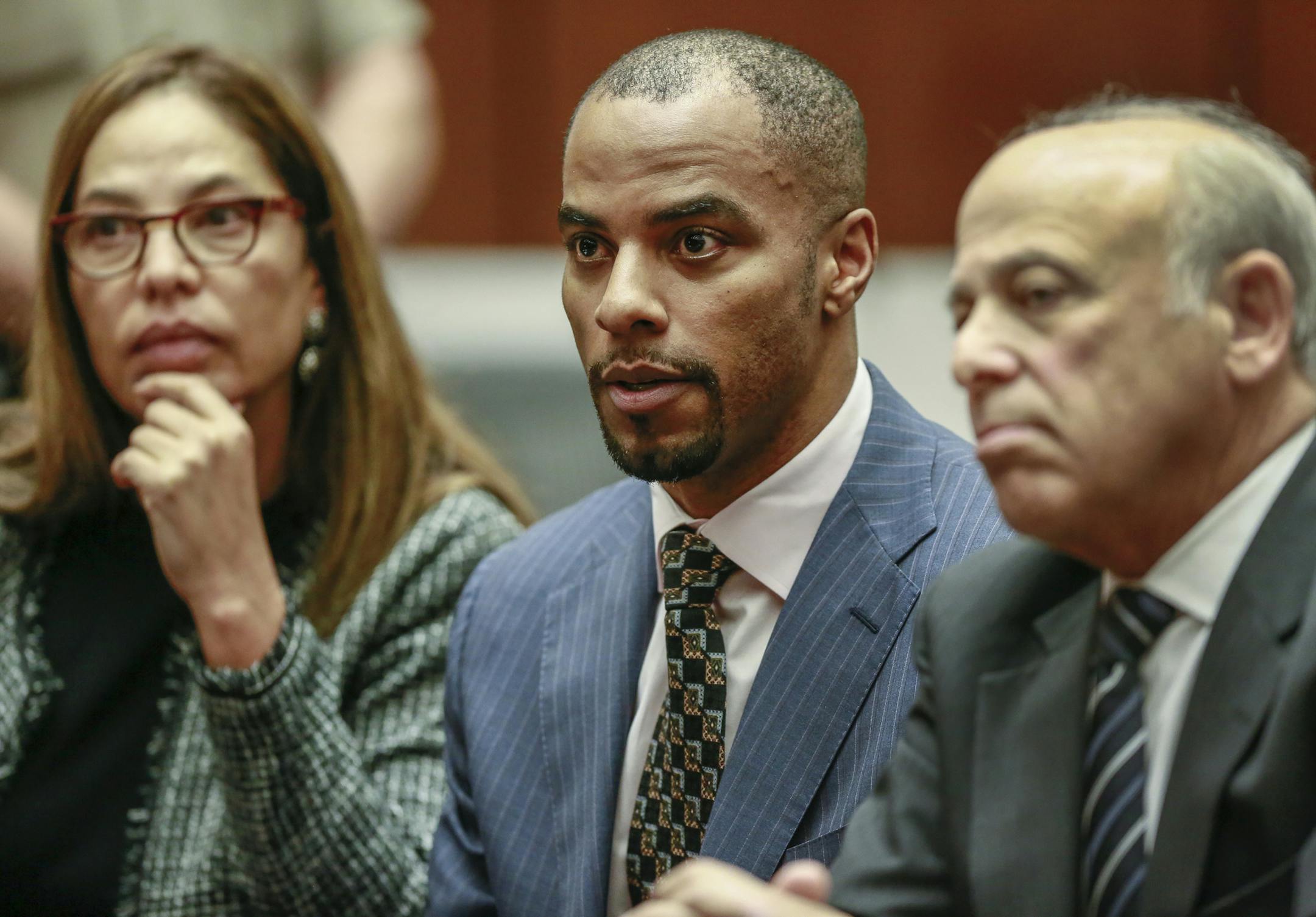 FILE - In this March 23, 2015, file photo, former NFL safety Darren Sharper, center, is flanked by his attorneys, Lisa Wayne, left, and Leonard Levine, right, in Los Angeles Superior Court. The sentencing of former New Orleans Saints player Darren Sharper on federal charges that he drugged and assaulted women in four states has been rescheduled. U.S. District Judge Jane Triche Milazzo issued an order Thursday, July 16, 2015, resetting Sharper's sentencing for Oct. 1 at the request of probation o