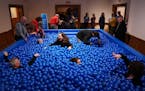 Guests played in the ball pit set up in the Swedish Institute's ballroom at "The American Swedish Institute. At Play," a multilayered exhibition that 