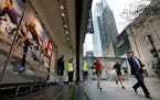Pedestrians and runners passed a window display at the new Sports Authority downtown Minneapolis store on the Nicollet Mall. ] CARLOS GONZALEZ cgonzal
