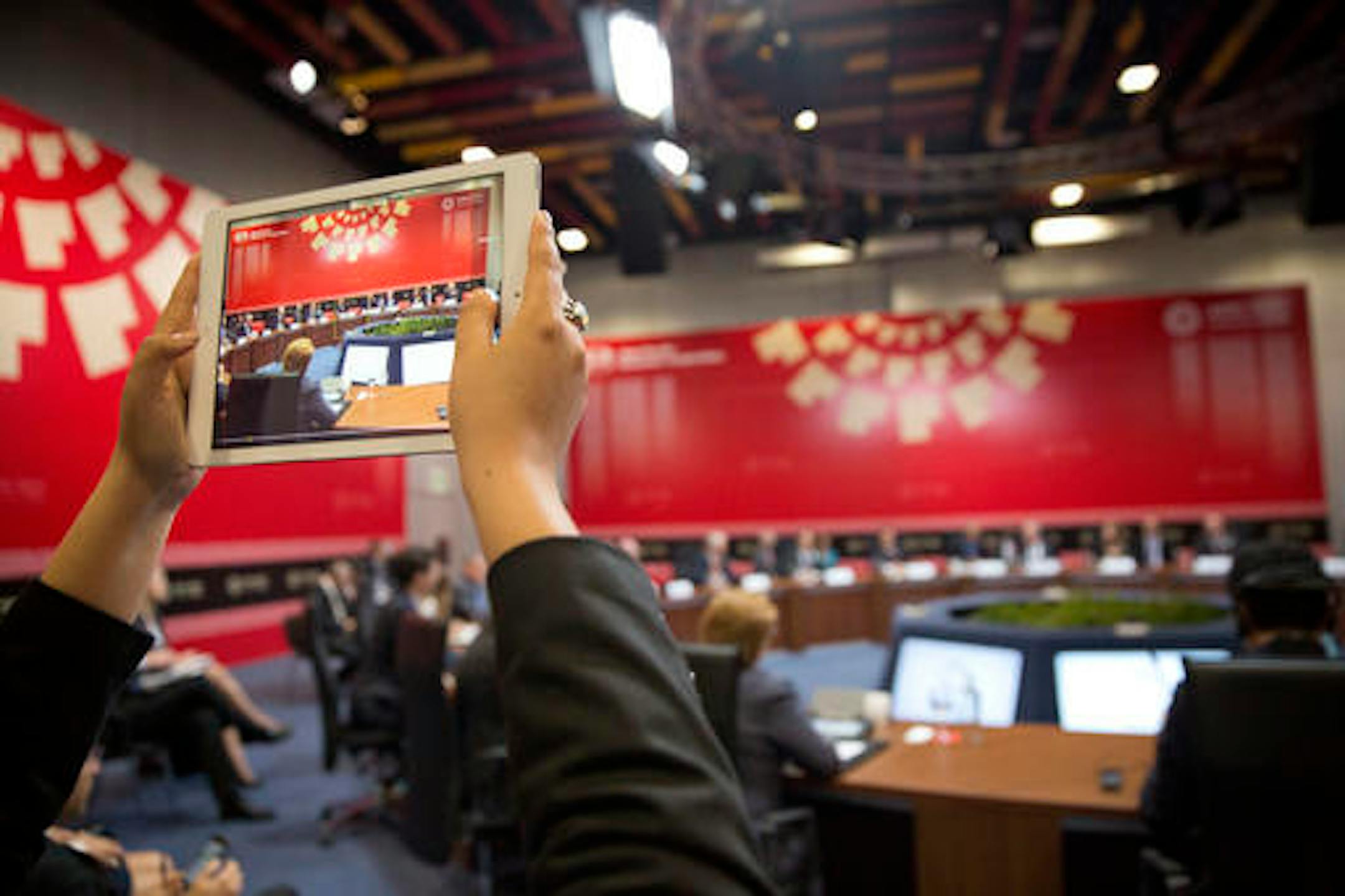 A member of the international media uses a tablet to record US President Barack Obama meeting with with leaders from Trans-Pacific Partnership (TPP), in Lima, Peru, Saturday, Nov. 19, 2016. (AP Photo/Pablo Martinez Monsivais)