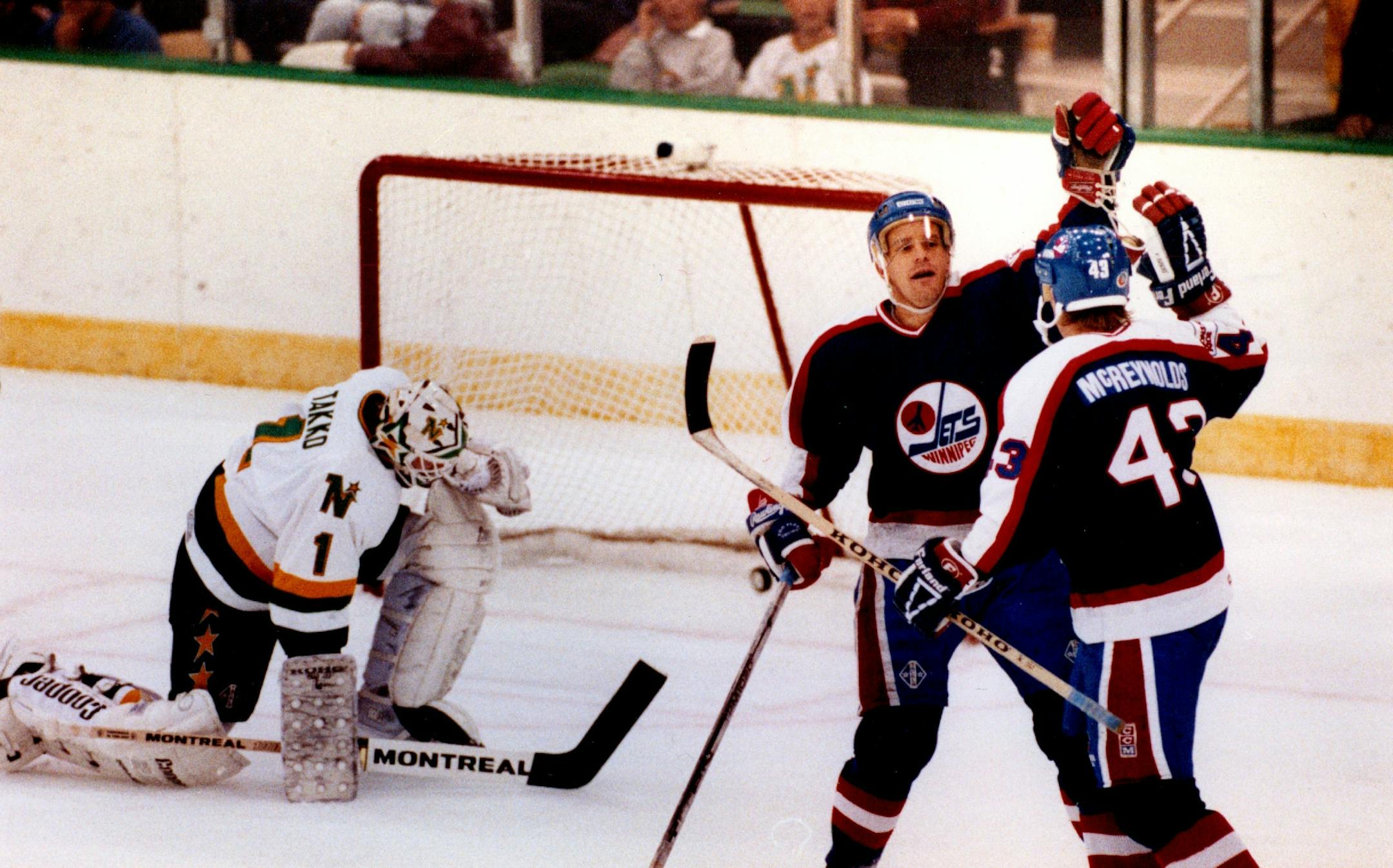 September 26, 1989 Winnipeg #11 Paul Fenton congratulated #43 Brian McReynolds after he scored the Jet's first goal in the first period. October 1989 Bruce Bisping, Minneapolis Star Tribune
