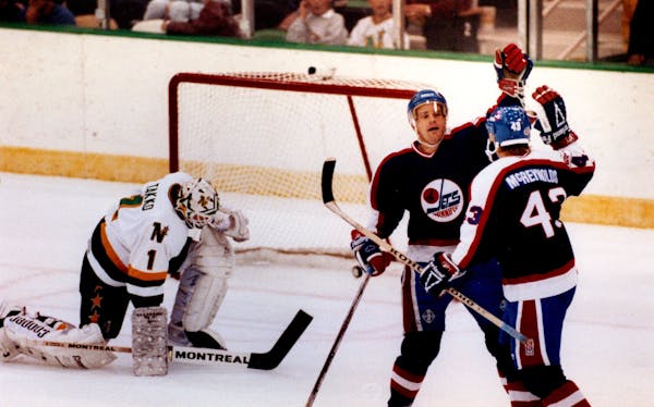 September 26, 1989 Winnipeg #11 Paul Fenton congratulated #43 Brian McReynolds after he scored the Jet's first goal in the first period. October 1989 