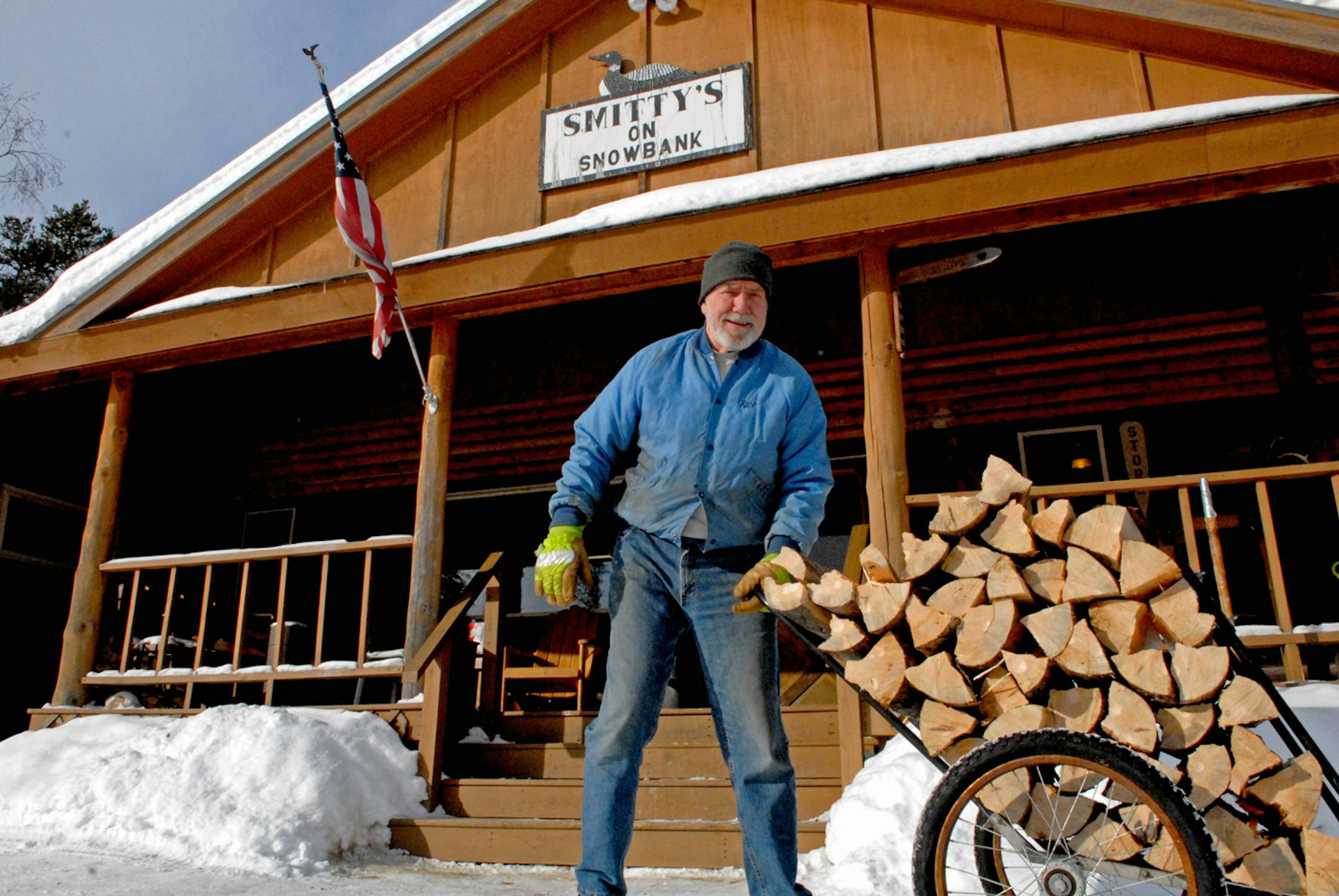 Ron Schmidt of Smitty's Resort on Snowbank Lake pulls a load of wood into his lodge.