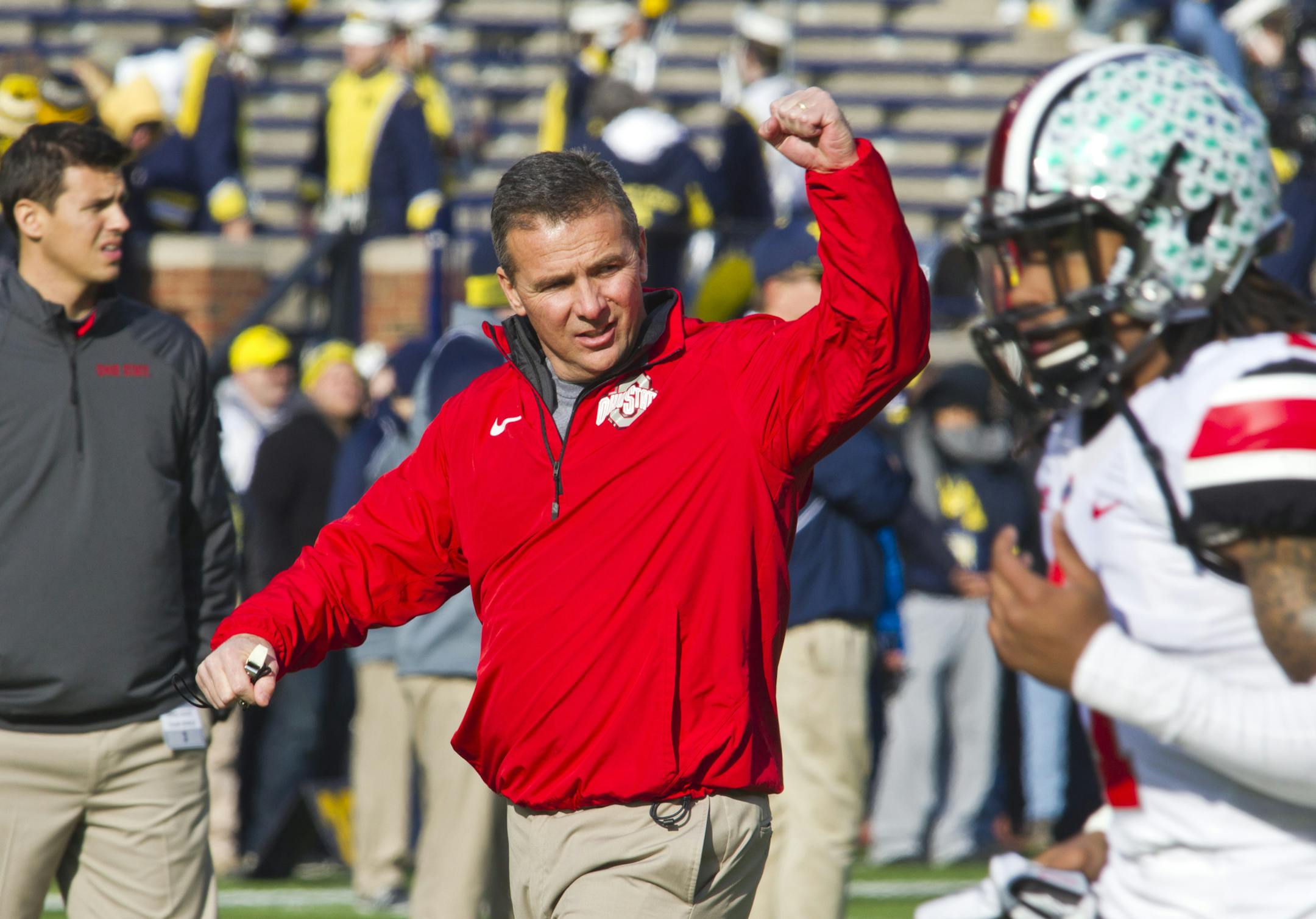 Ohio State head coach Urban Meyer responds to cheers from fans in Michigan Stadium as his team takes the field against Michigan.