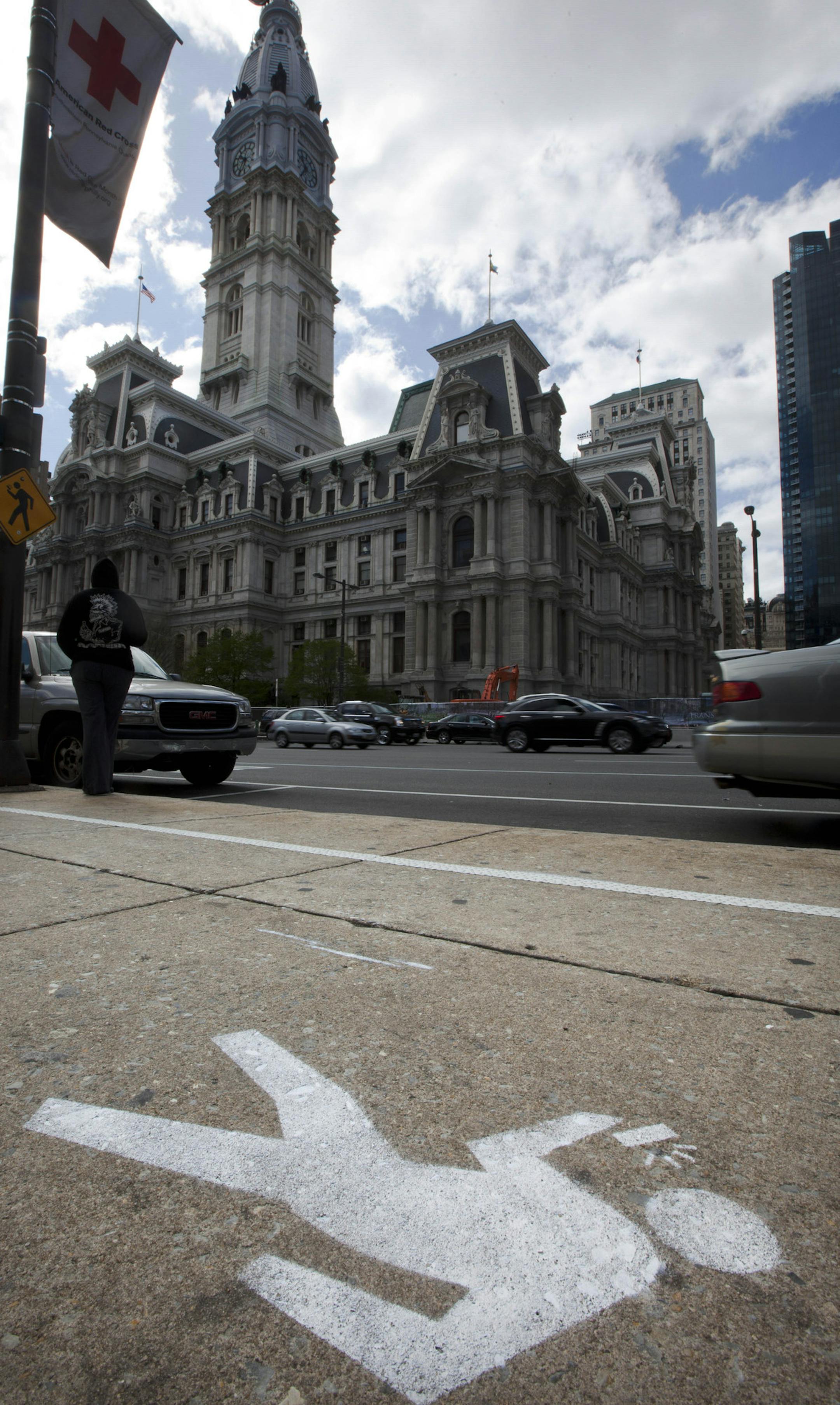 An "e-lane" sidewalk graphic displays in view of City Hall, Monday, April 2, 2012, in Philadelphia. Philadelphia Mayor Michael Nutter used April Fool's Day to have a little fun with what he says is a real problem: distracted walking. City officials painted lines and oblivious stick-figure pictures on one stretch of John F. Kennedy Boulevard near City Hall as a jab at pedestrians who keep their eyes on their cellphone screens and not their surroundings. (AP Photo/Matt Rourke)