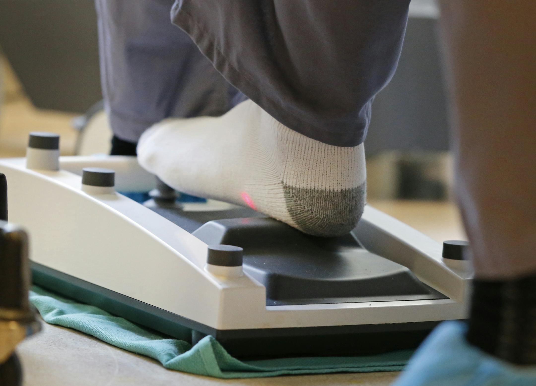 Dr. Walter Parker removed his shoes and manipulated with his socked feet the microscope through which he viewed patients' eyes during surgery.