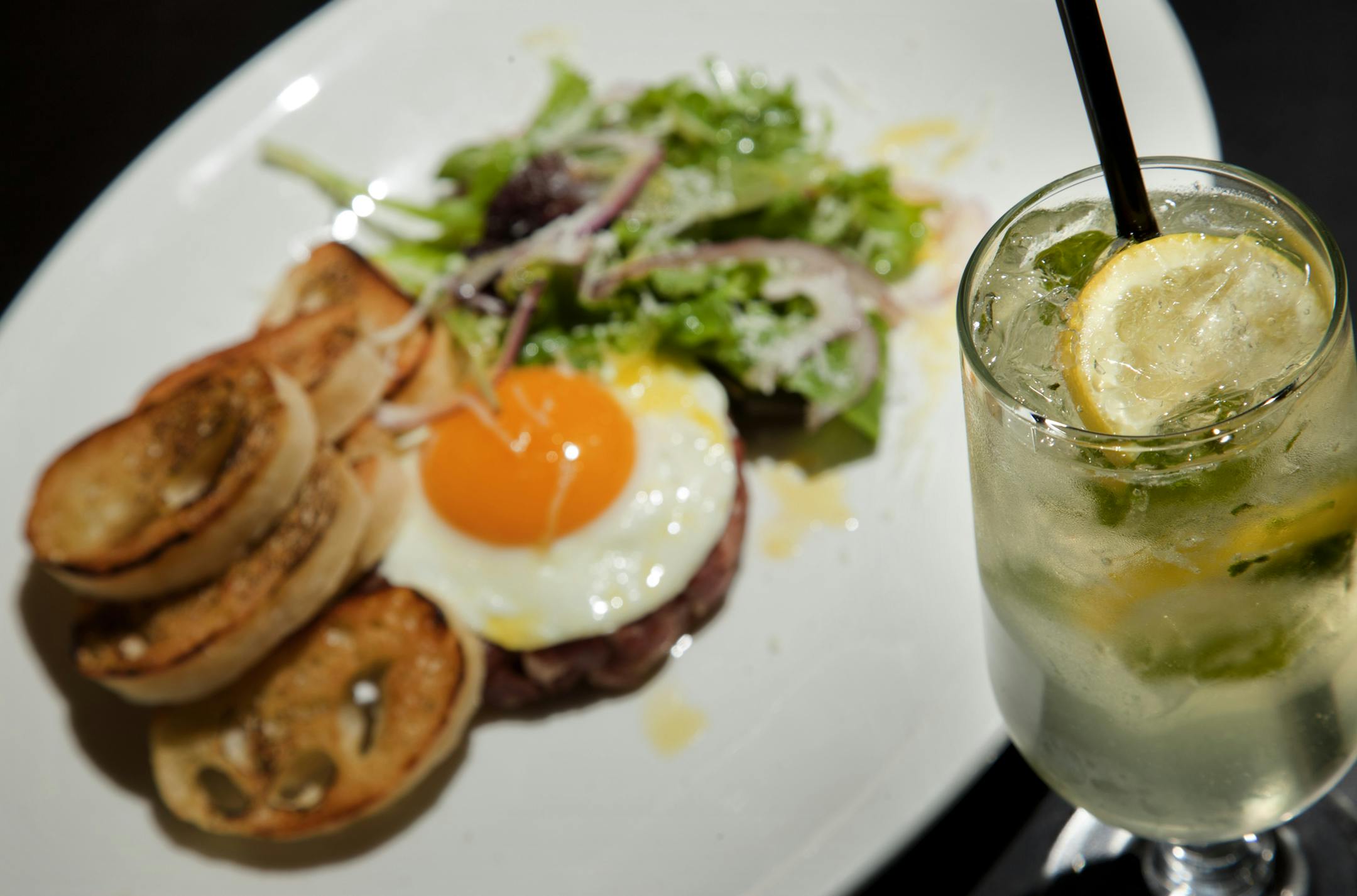 "The Gooch": Boomsma young genever gin, Lillet, ripped sage, Gmork, Gruner Veltliner Grassfed Beef Tenderlion Schiacciatta with crostini, egg, market greens, red onion, pecorino nuts, and white truffle oil. At The Strip Club Meat & Fish in St. Paul, Minn. ] CARLOS GONZALEZ cgonzalez@startribune.com, March 7, 2012, Minneapolis, Minn, Vita.mn, Beyond The Bloody Mary Drink ORG XMIT: MIN2012092514030761