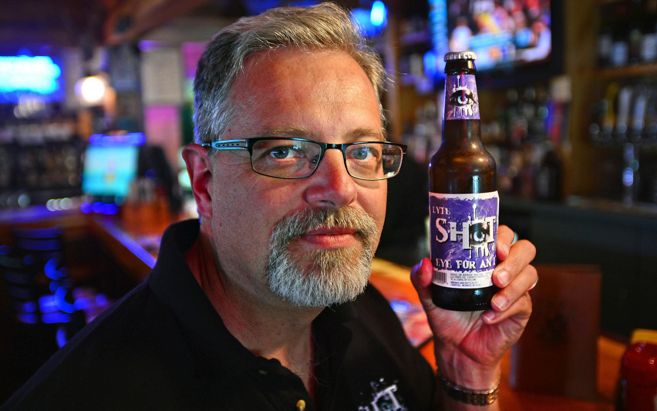 Serial entrepreneur Scott Schwalbe is taking a shot at Big Beer with his own brew, Shot Beer. He believes there's an opportunity to take on mass-produced Bud, Miller and Coors with what he believes is a better-tasting beer with a brand and marketing that will appeal to drinkers in their 20s and 30s. Scott Schwalbe held a bottle of Shot Beer in the bar at the Buffalo Tap in Savage, Minn. on Tuesday afternoon July 2, 2013 ] Richard.Sennott@startribune.com Richard Sennott/Star Tribune Savage Minnes