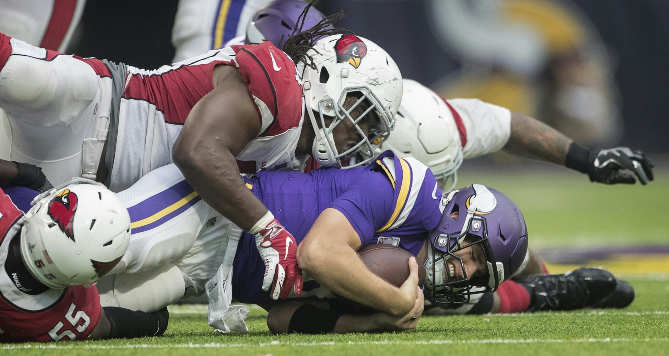 Minnesota Vikings quarterback Kirk Cousins (8) was sacked by Arizona Cardinals defensive end Markus Golden (44) in the fourth quarter at U.S. Bank Stadium Sunday October 14, 2018 in Minneapolis, MN.
