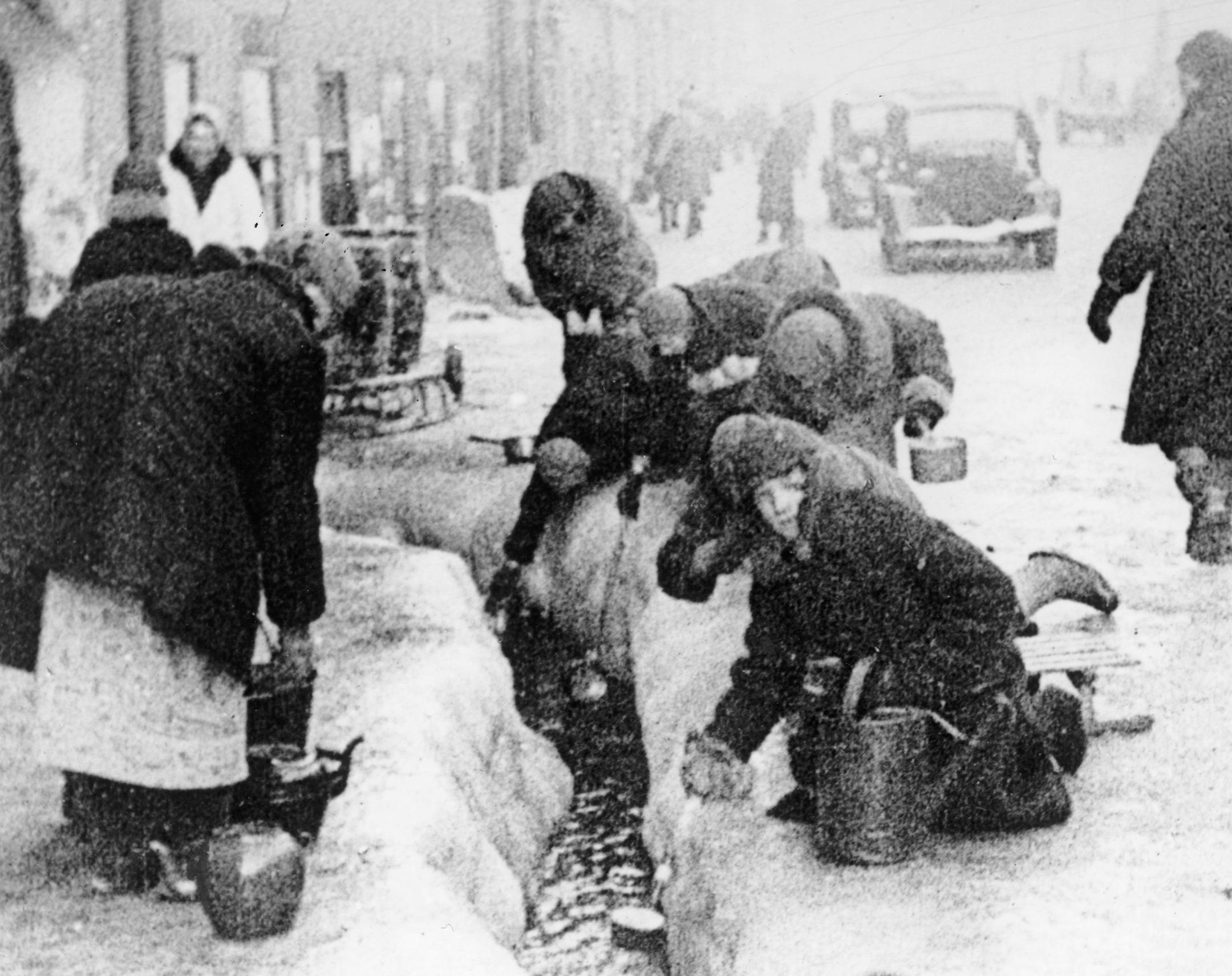 This photo, taken in the winter months of 1942, shows citizens of Leningrad as they dig up water from a broken main, during the 900-day siege of the Russian city by German invaders. (AP Photo) ORG XMIT: APHS229