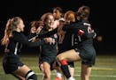 Stillwater teammates celebrate their overtime win against Lakeville North in the Class AAA quarterfinals in Edina, Minn., Tuesday, Oct. 26, 2021. ] RE