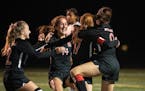 Stillwater teammates celebrate their overtime win against Lakeville North in the Class AAA quarterfinals in Edina, Minn., Tuesday, Oct. 26, 2021. ] RE