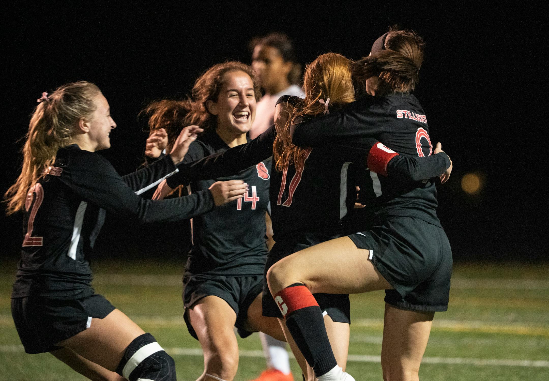 Stillwater teammates celebrate their overtime win against Lakeville North in the Class AAA quarterfinals in Edina, Minn., Tuesday, Oct. 26, 2021. ] RENEE JONES SCHNEIDER • renee.jones@startribune.com