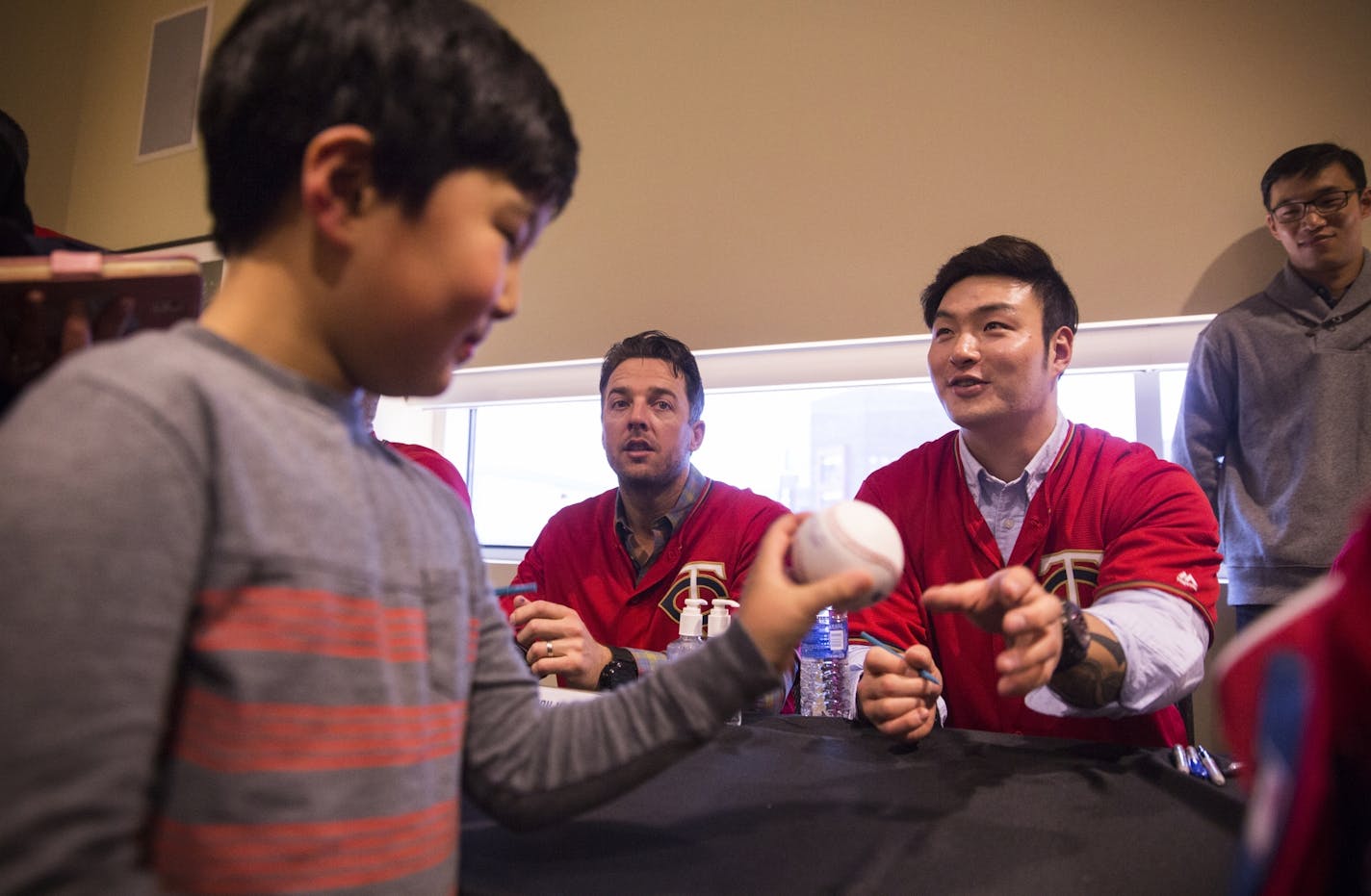 Daniel Kwon, 8, of Plymouth gets a baseball signed by new Twins player Byung Ho Park during TwinsFest at Target Field in Minneapolis on January 29, 2016. Kwon's family, which are Korean-American, came to TwinsFest for the first time this year because of Park.