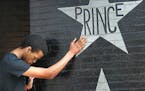 Antonio Carnell, 20, took a moment to touch Prince's star as many gathered at First Avenue after news of his death was made, Thursday, April 21, 2016 