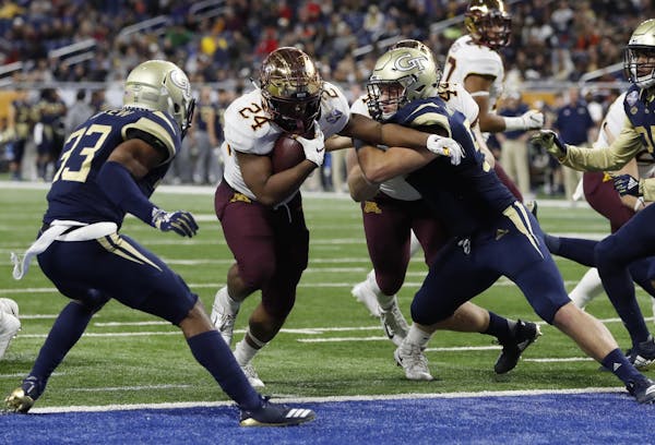 Minnesota running back Mohamed Ibrahim (24) breaks through the Georgia Tech defense for a 3-yard touchdown during the second half of the Quick Lane Bo