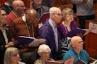 Marv and Elaine Lofquist, both in purple, are founding members of the Giving Voice chorus, which has been bringing together people with dementia and t