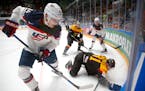 In this May 15, 2016 file photo, the United States' Auston Matthews, left, fought for the puck with Germany's Torsten Ankert during a Hockey World Cha