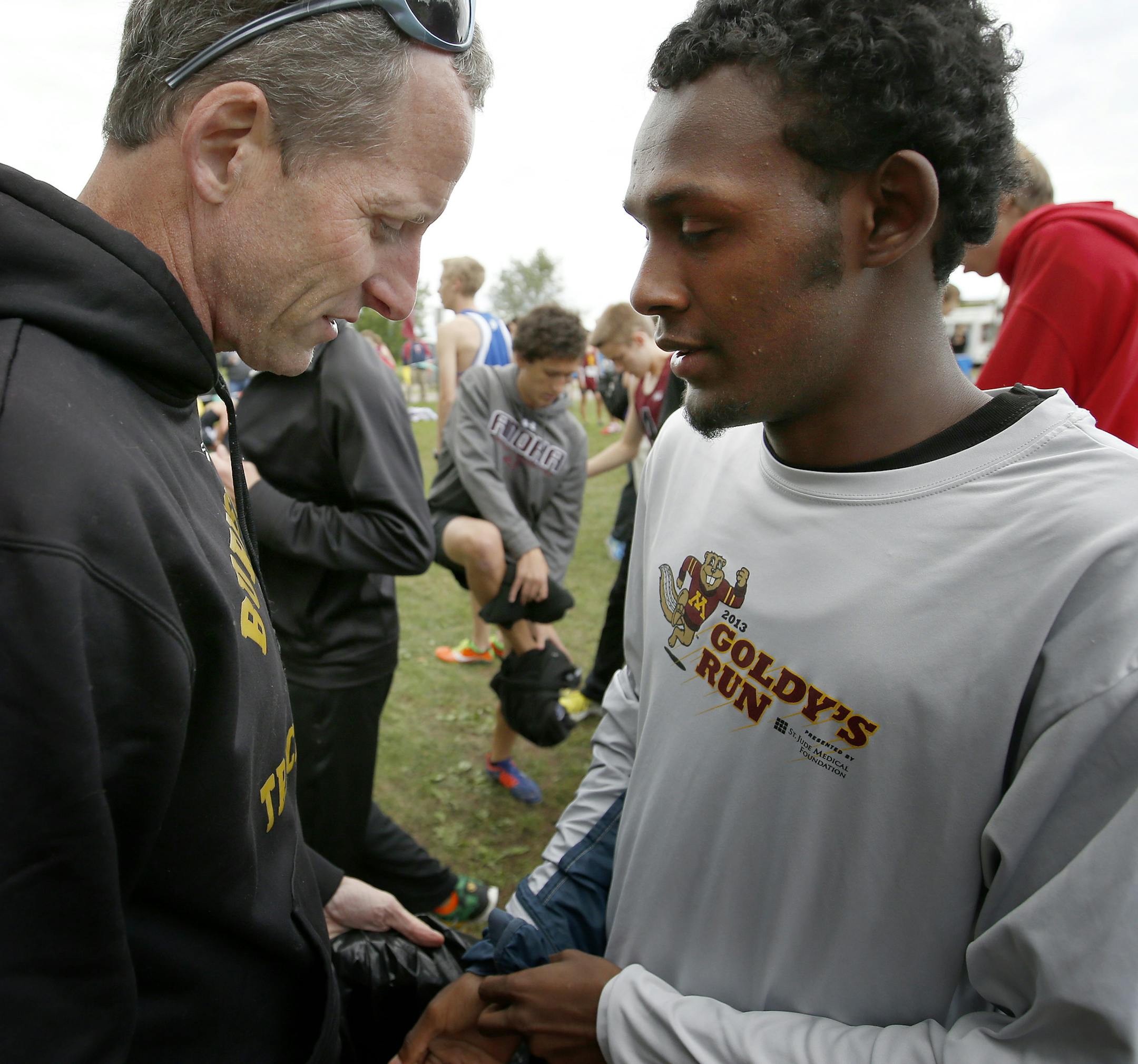 Faysal Mahmoud of Burnsville High School spoke to coach Jeff Webber before the start Anoka Invitational. ] CARLOS GONZALEZ cgonzalez@startribune.com - September 11, 2014, Anoka, Minn., Burnsville boys' high school / prep cross country runner Faysal Mahmoud will be competing in the Anoka Invitational.