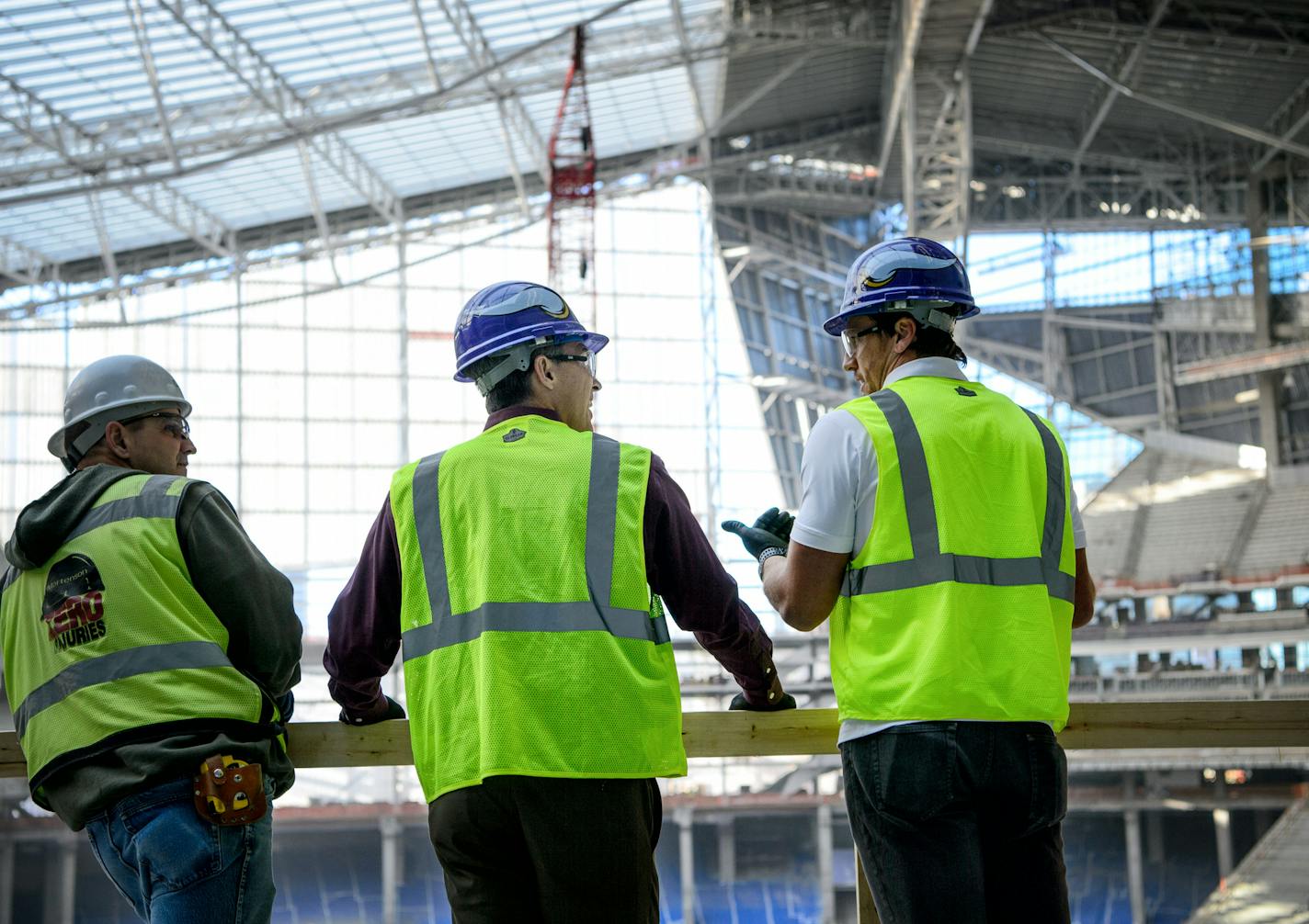 Polaris CEO Scott Wine, center, looked out over the new stadium with Vikings linebacker Chad Greenway, right, and construction superintendent Dave Mensell, after a Polaris photo shoot outside USBank Stadium Monday afternoon. ] GLEN STUBBE * gstubbe@startribune.com Monday, November 9, 2015 Polaris Industries has signed a 10-year multi-million contract with the Vikings that will name a gate at the new stadium the Polaris gate and offer a Polaris hallway of products for fans.