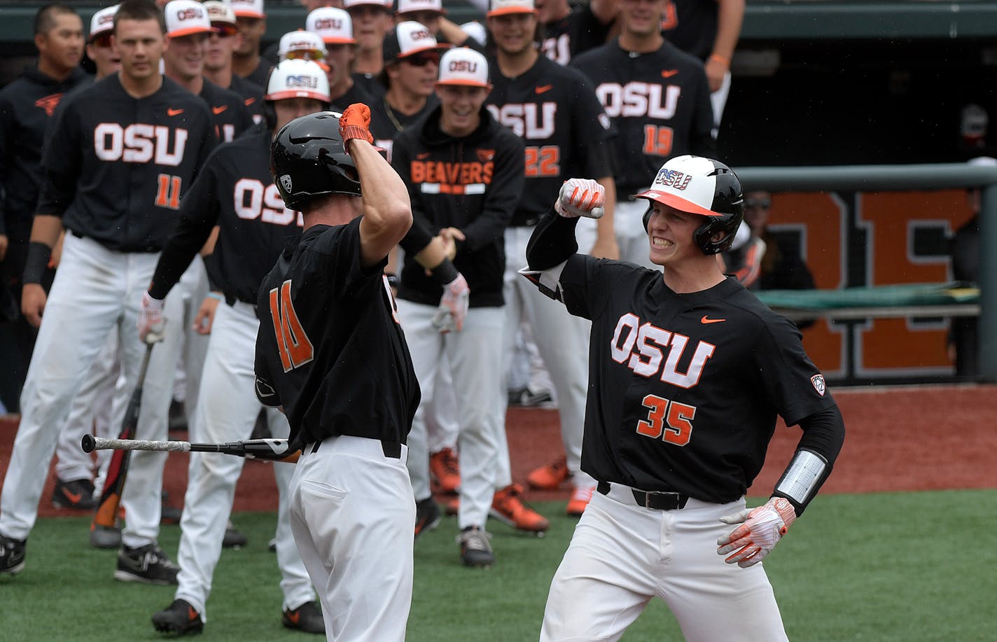 Oregon State's Adley Rutschman (35) celebrates with Micahel Gretler (10) after hitting a solo home run in the first inning of the Corvallis Super Regional