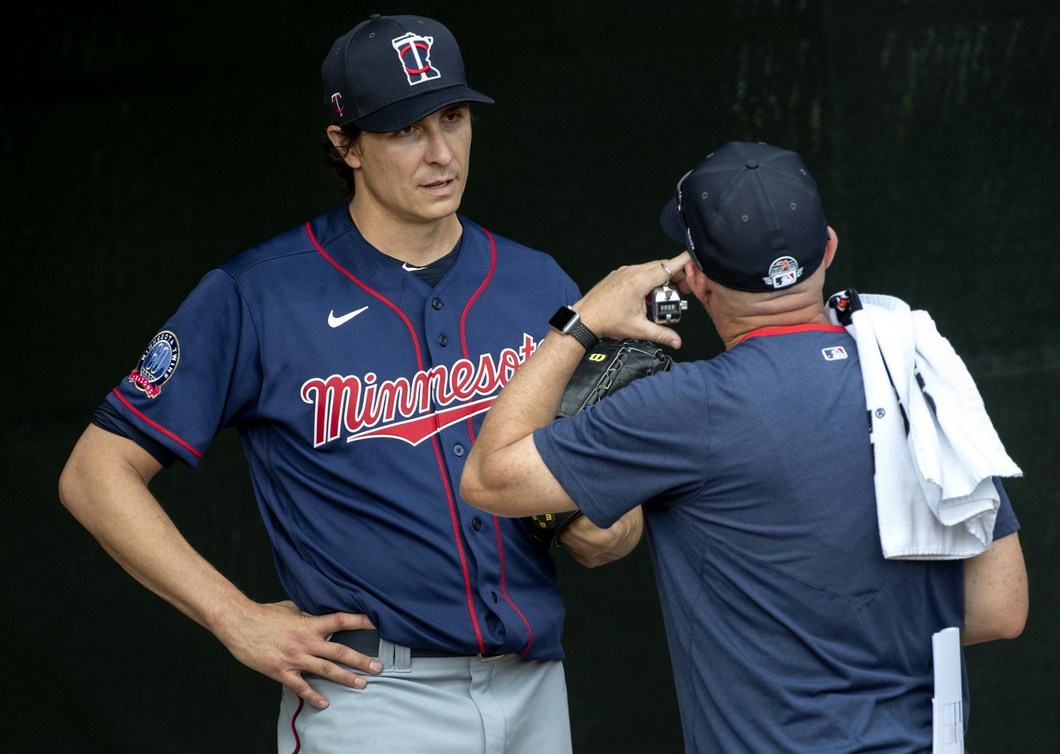 Minnesota Twins pitcher Homer Bailey spoke to a coach after throwing in the bullpen.