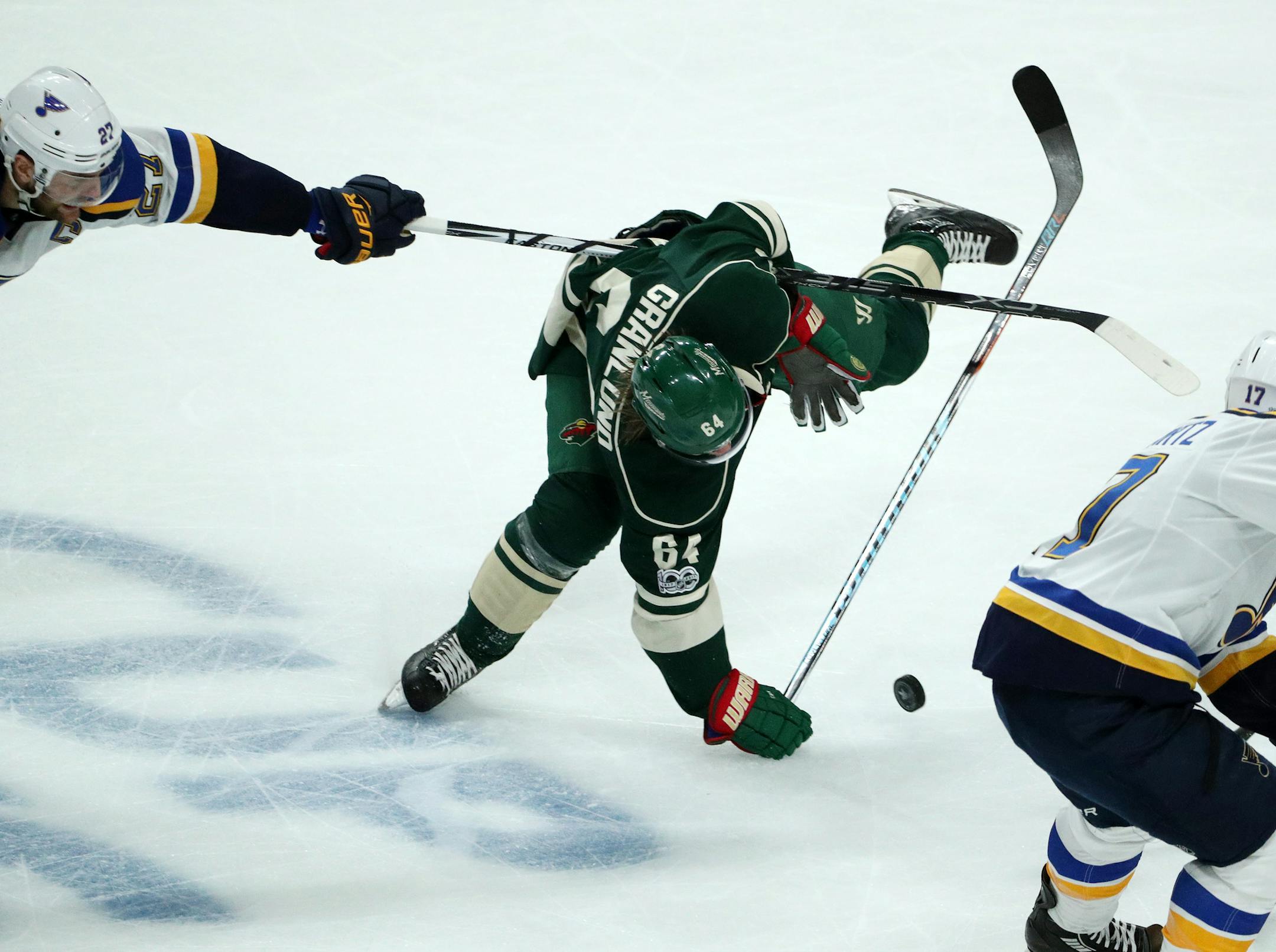 Minnesota Wild center Mikael Granlund (64) gets tripped up by St. Louis Blues left wing David Perron (57) while skating with the puck in the second period. ] ANTHONY SOUFFLE ï anthony.souffle@startribune.com Game action from an NHL playoff game 2 between the Minnesota Wild and the St. Louis Blues Friday, April 14, 2017 at the Xcel Energy Center in St. Paul, Minn.