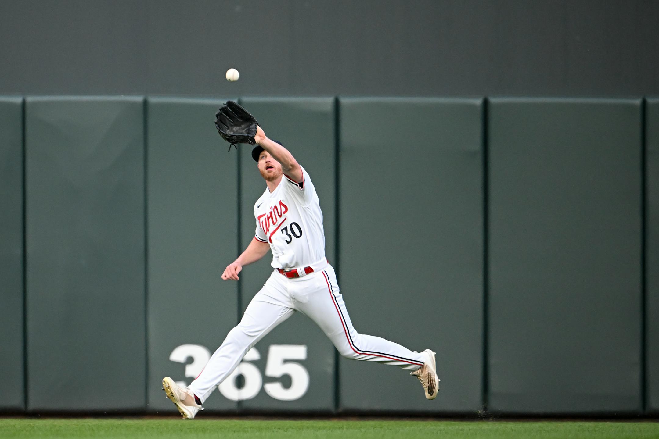Minnesota Twins left fielder Kyle Garlick catches a ball hit by San Francisco Giants left fielder LaMonte Wade Jr. in the top of the fifth inning.
