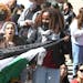 Several hundred students and pro-Palestinian supporters rally at the intersection of Grove and College Streets, in front of Woolsey Hall on the campus