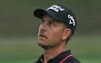 Henrik Stenson watches his approach shot on the first hole during the third round of the PGA Championship golf tournament at Baltusrol Golf Club in Sp