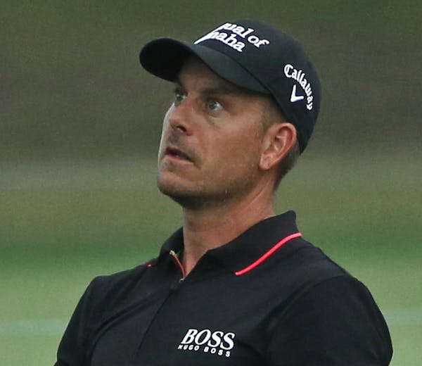 Henrik Stenson watches his approach shot on the first hole during the third round of the PGA Championship golf tournament at Baltusrol Golf Club in Sp