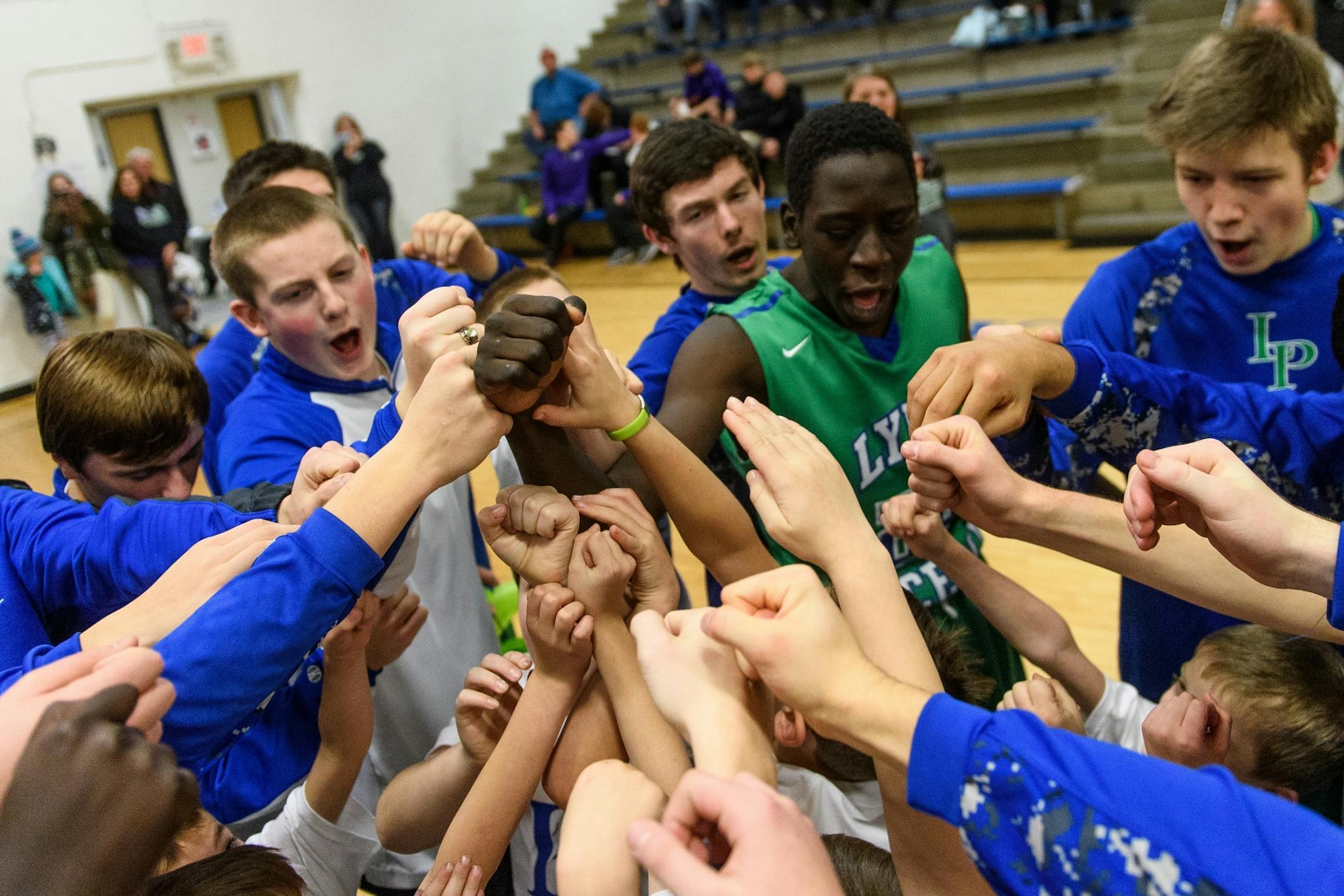 Lyle-Pacelli huddled up before the start of their game Friday night against Grand Meadow.