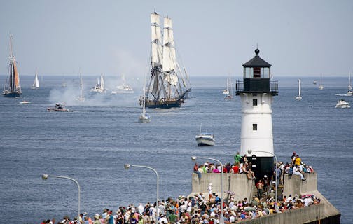 The U.S. Brig Niagara and the Roseway approach crowd of viewers and the ship canal during the Duluth Tall Ships festival parade of sails Thursday July 29, 2010 in Duluth, Minn. (AP Photo/Duluth News Tribune, Clint Austin)