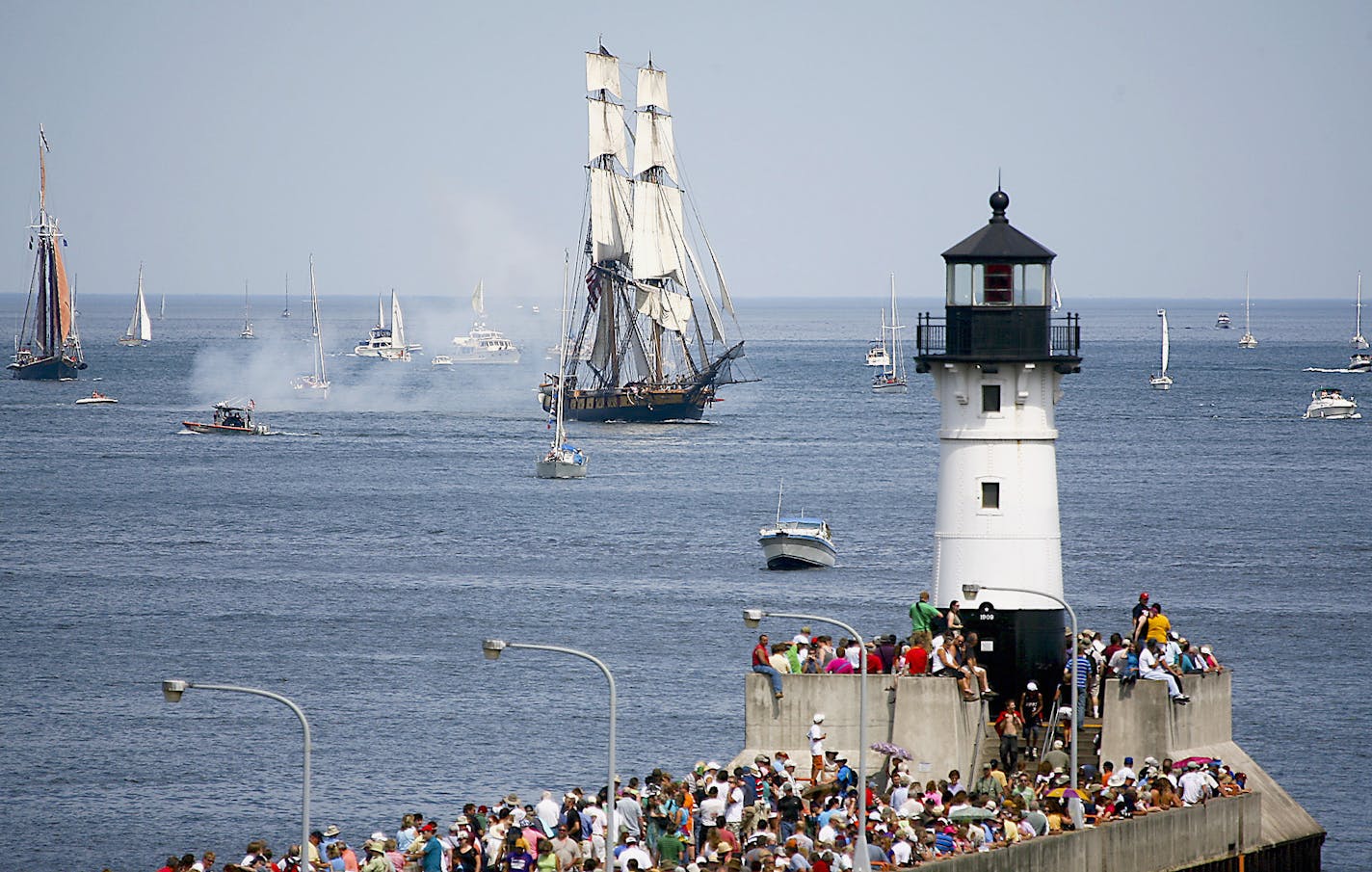 The U.S. Brig Niagara and the Roseway approach crowd of viewers and the ship canal during the Duluth Tall Ships festival parade of sails Thursday July 29, 2010 in Duluth, Minn. (AP Photo/Duluth News Tribune, Clint Austin)