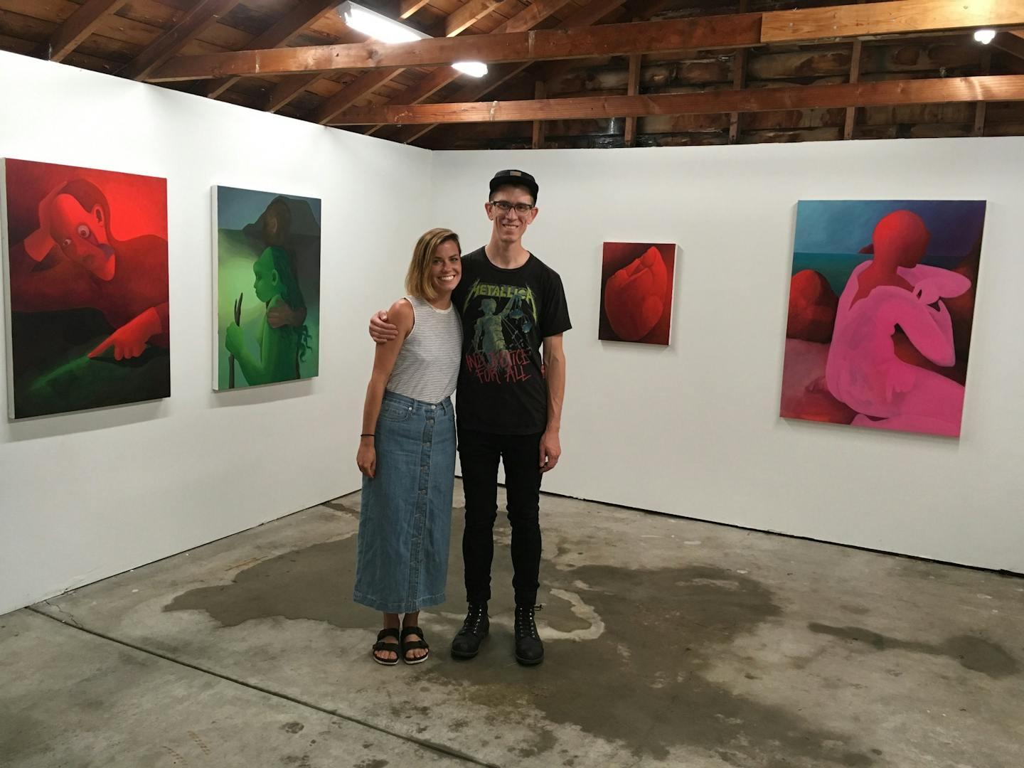 Jennie Ekstrand and Patrick Gantert of Sadie Halie Projects turned their Minneapolis garage into a gallery. Behind them were paintings from a recent show by Kristen Sanders. (photo by Alicia Eler, Star Tribune)