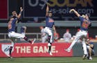 Twins left fielder Eddie Rosario, left, center fielder Byron Buxton, center, and right fielder Max Kepler celebrate a 8-7 win over the Los Angeles Ang