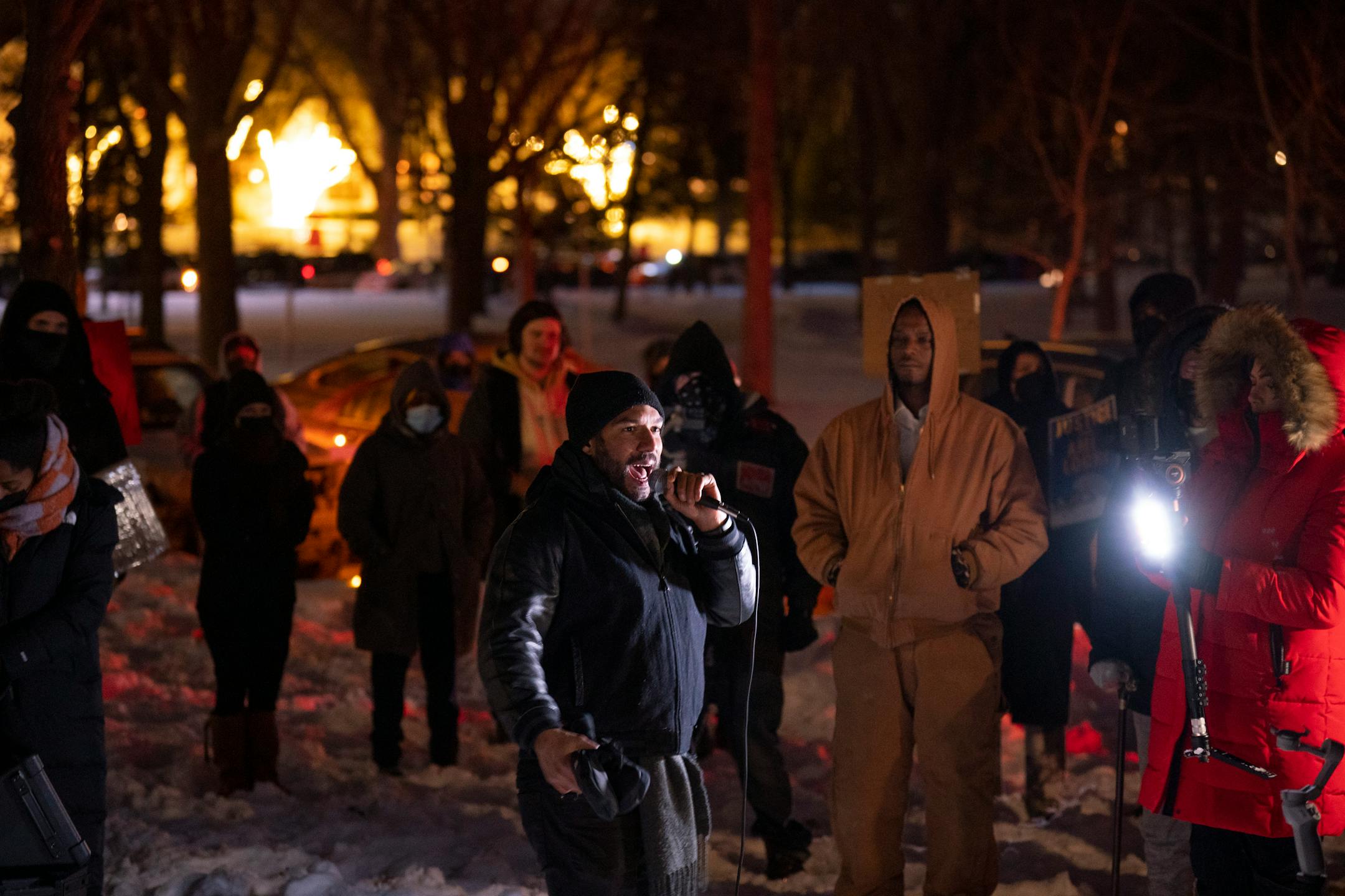 Demonstrators listened to Toussaint Morrison&nbsp;&nbsp;&nbsp; while gathered outside homes in the Cedar-Isles-Dean on Sunday night, February 6, 2022 in Minneapolis.